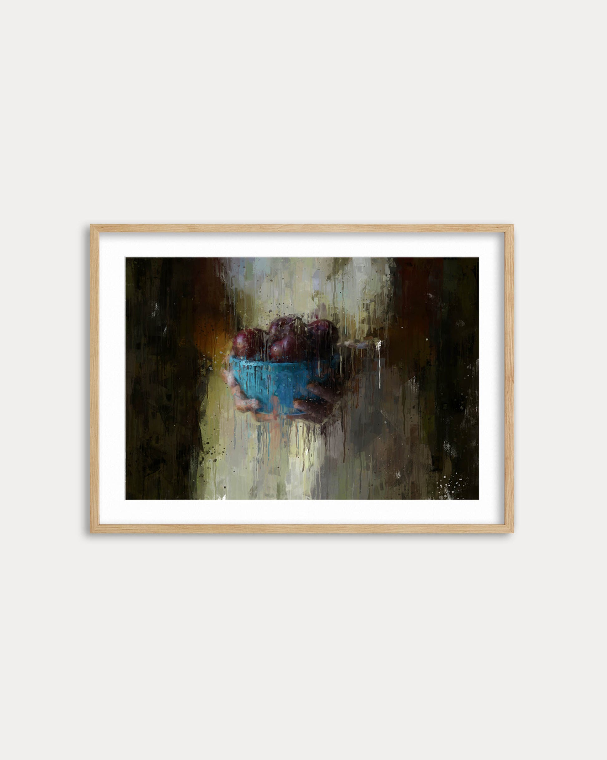 Framed painting of a hand holding a blue bowl with grapes on a white wall