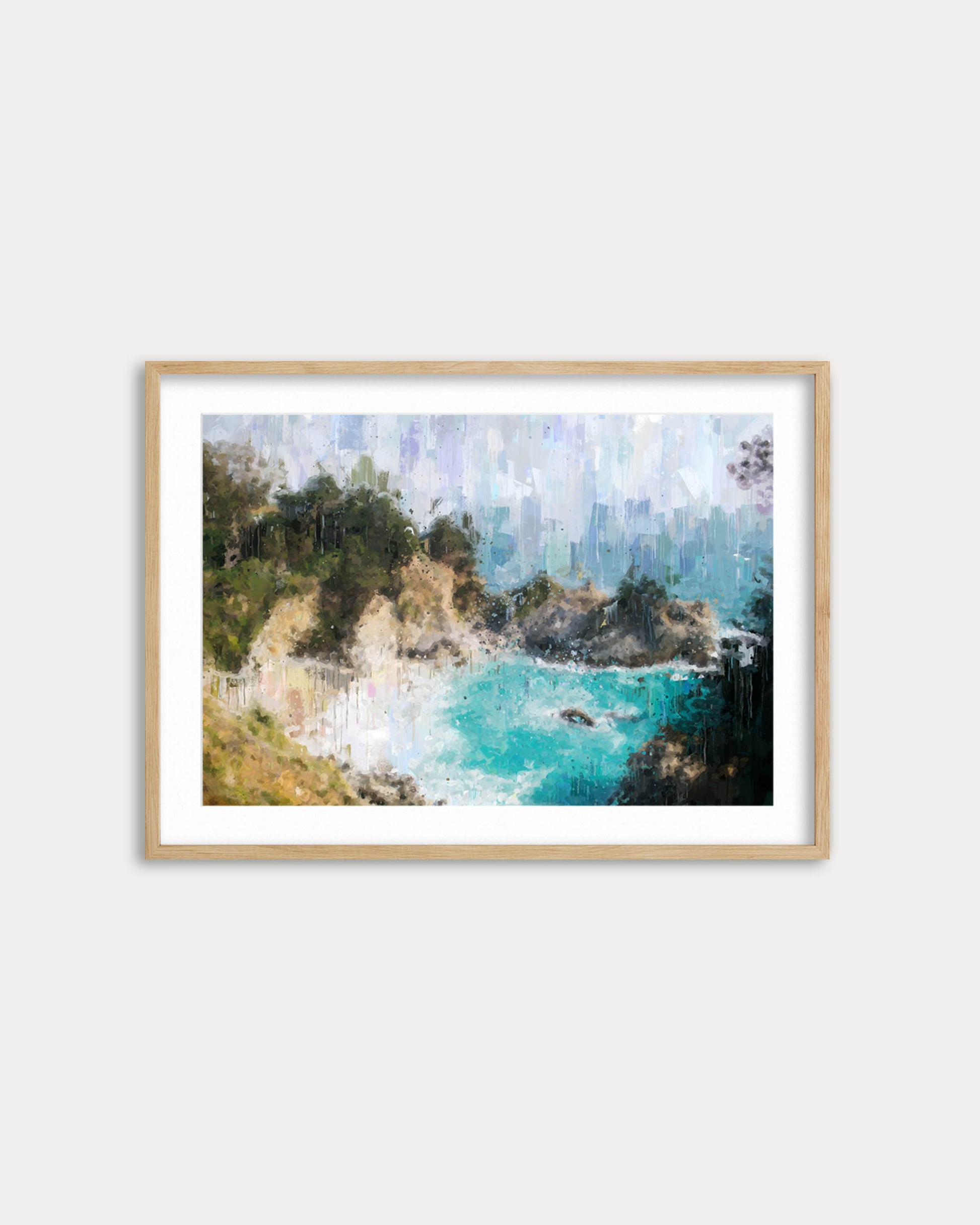 Framed artwork of a coastal scene with turquoise water and greenery on a white wall.
