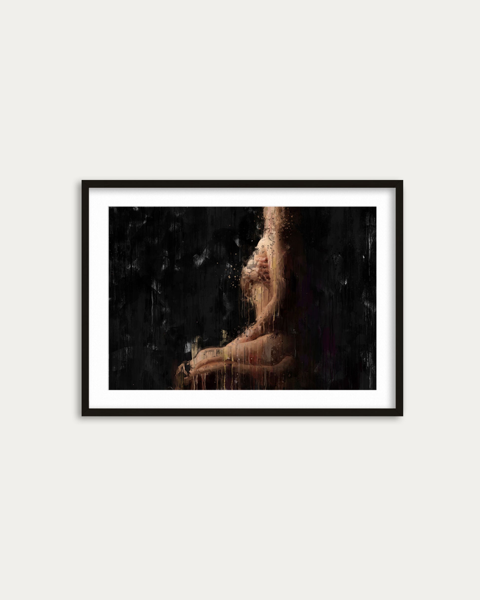 Framed artwork of a nude figure against a dark background on a white wall