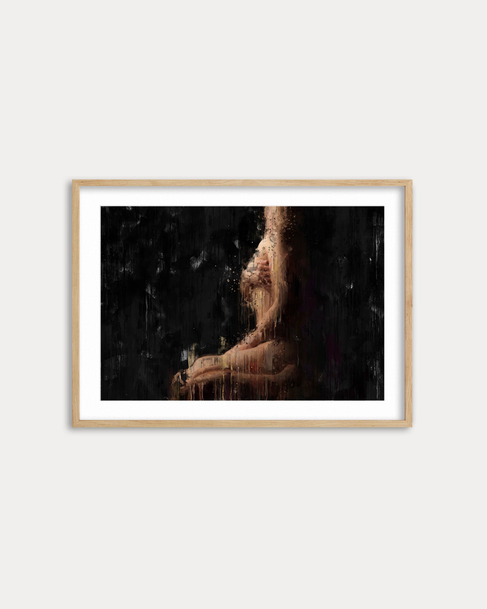 Framed artwork of a person against a dark background on a white wall