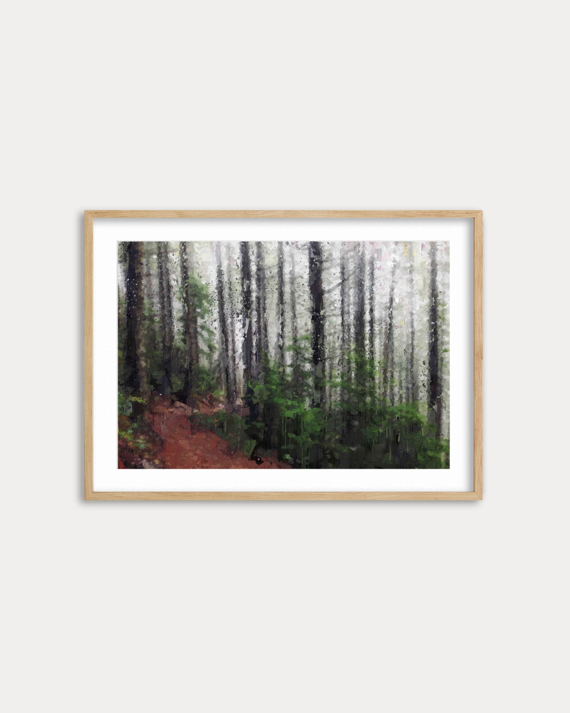Framed artwork of a forest path on a white wall