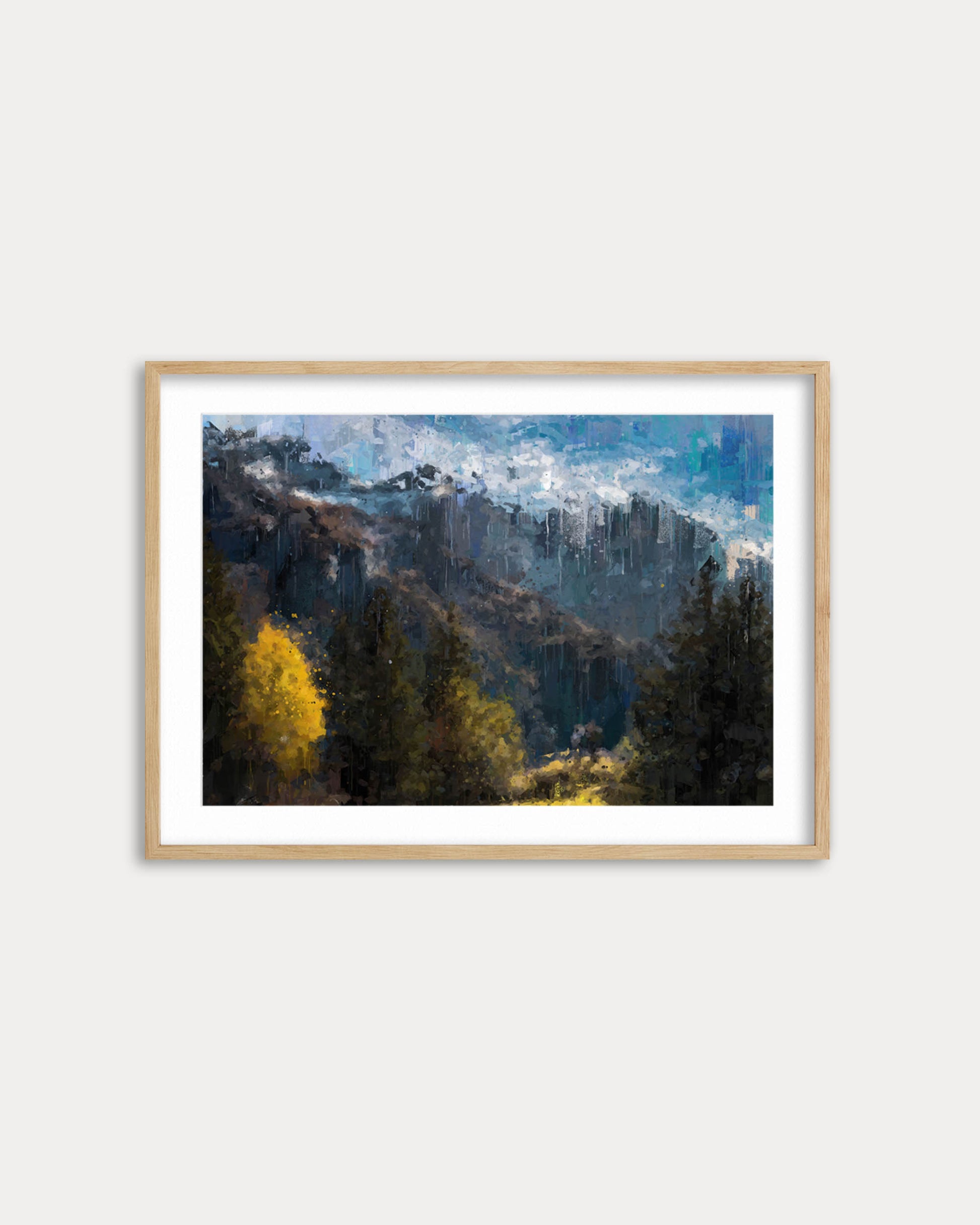 Framed artwork of a mountain landscape with trees on a white wall