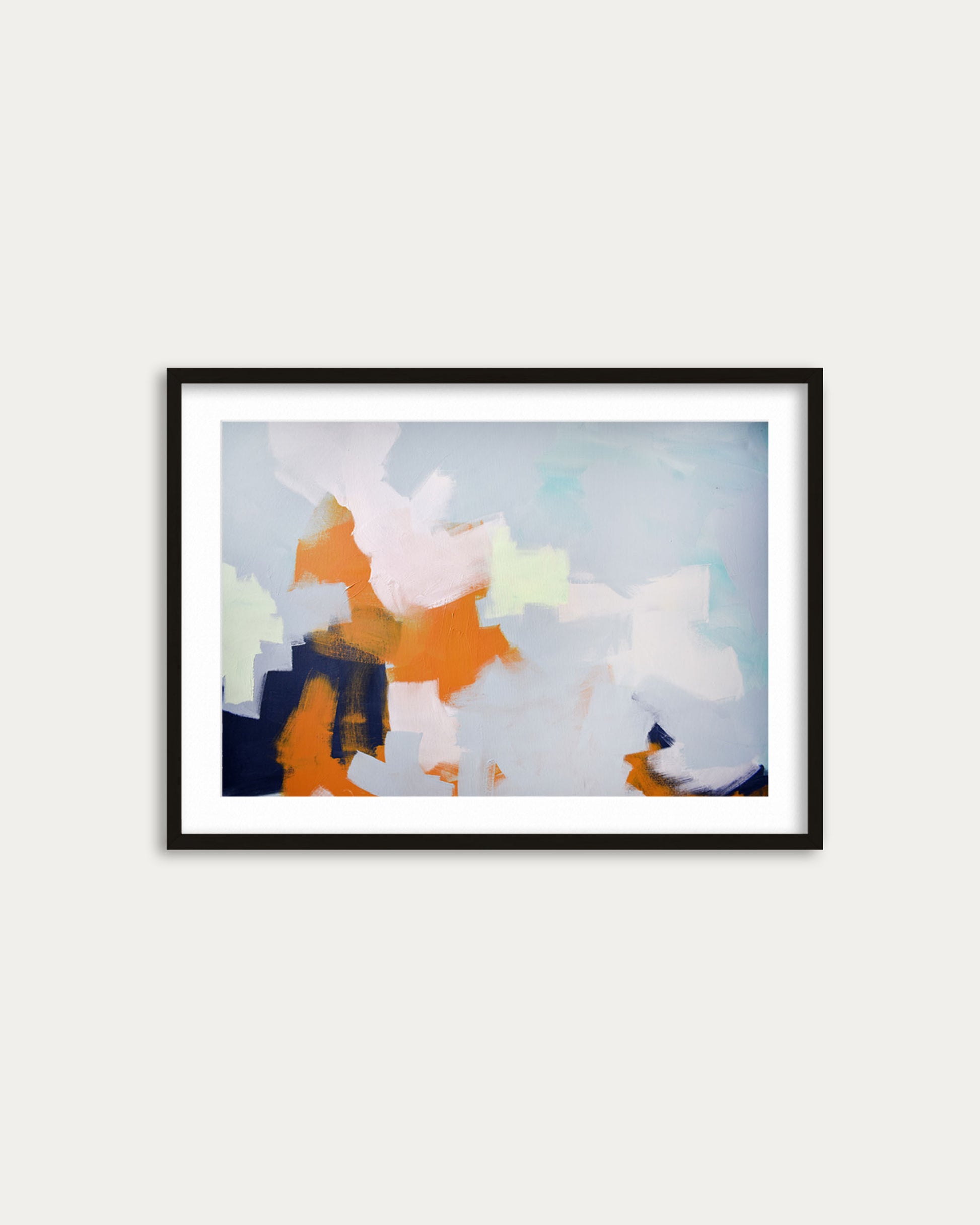 Framed abstract artwork with colorful patterns on a white wall