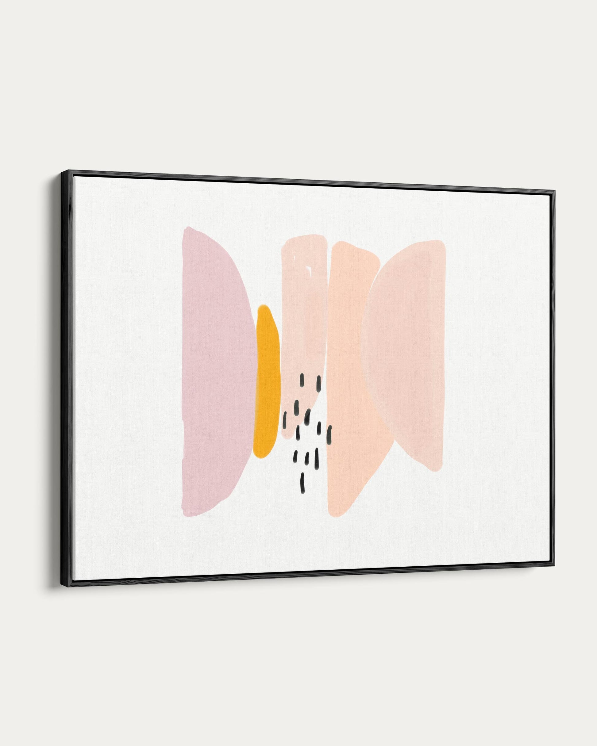 Framed abstract art with pink and yellow shapes on a white wall