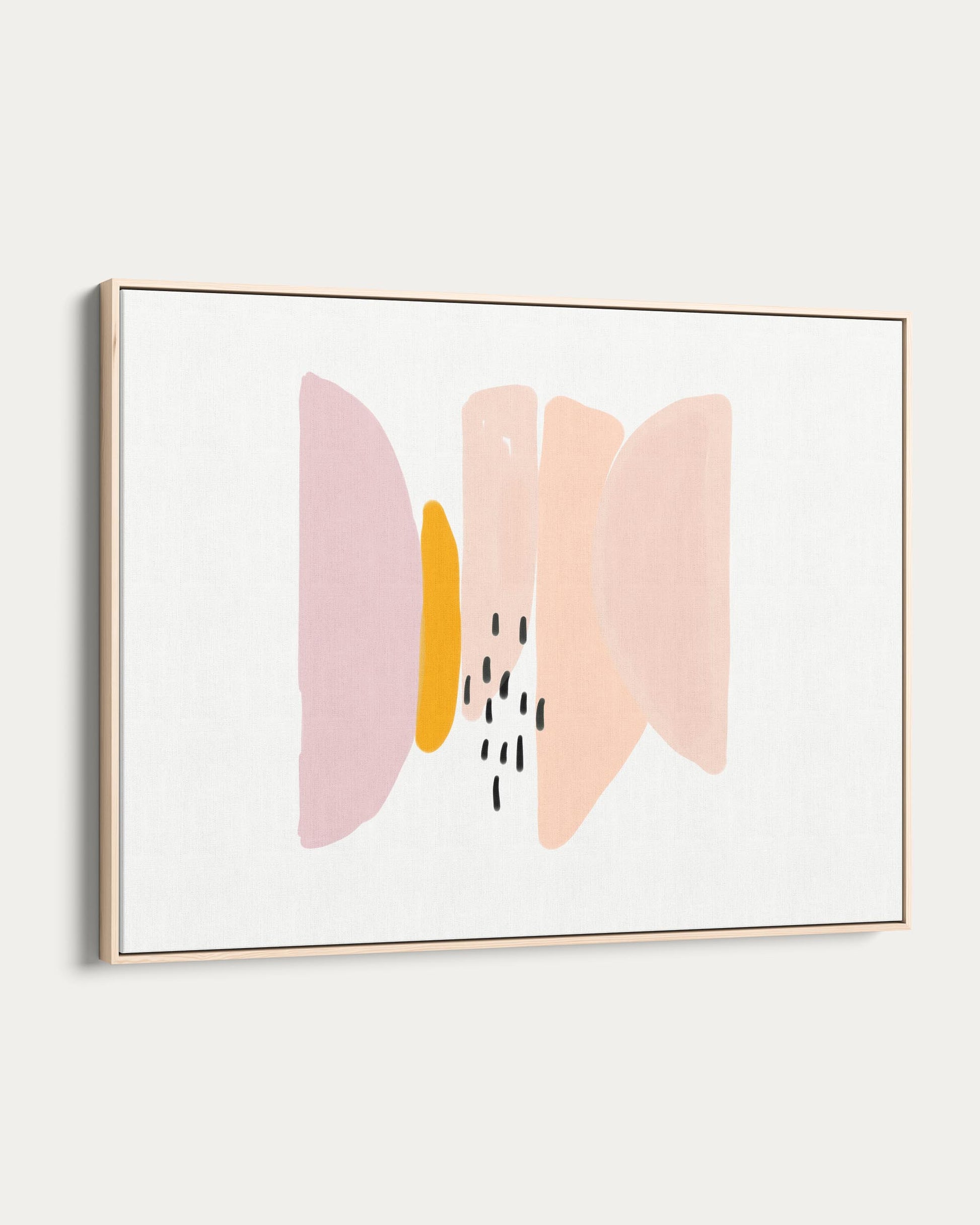 Framed abstract art with pink and yellow shapes on a white wall