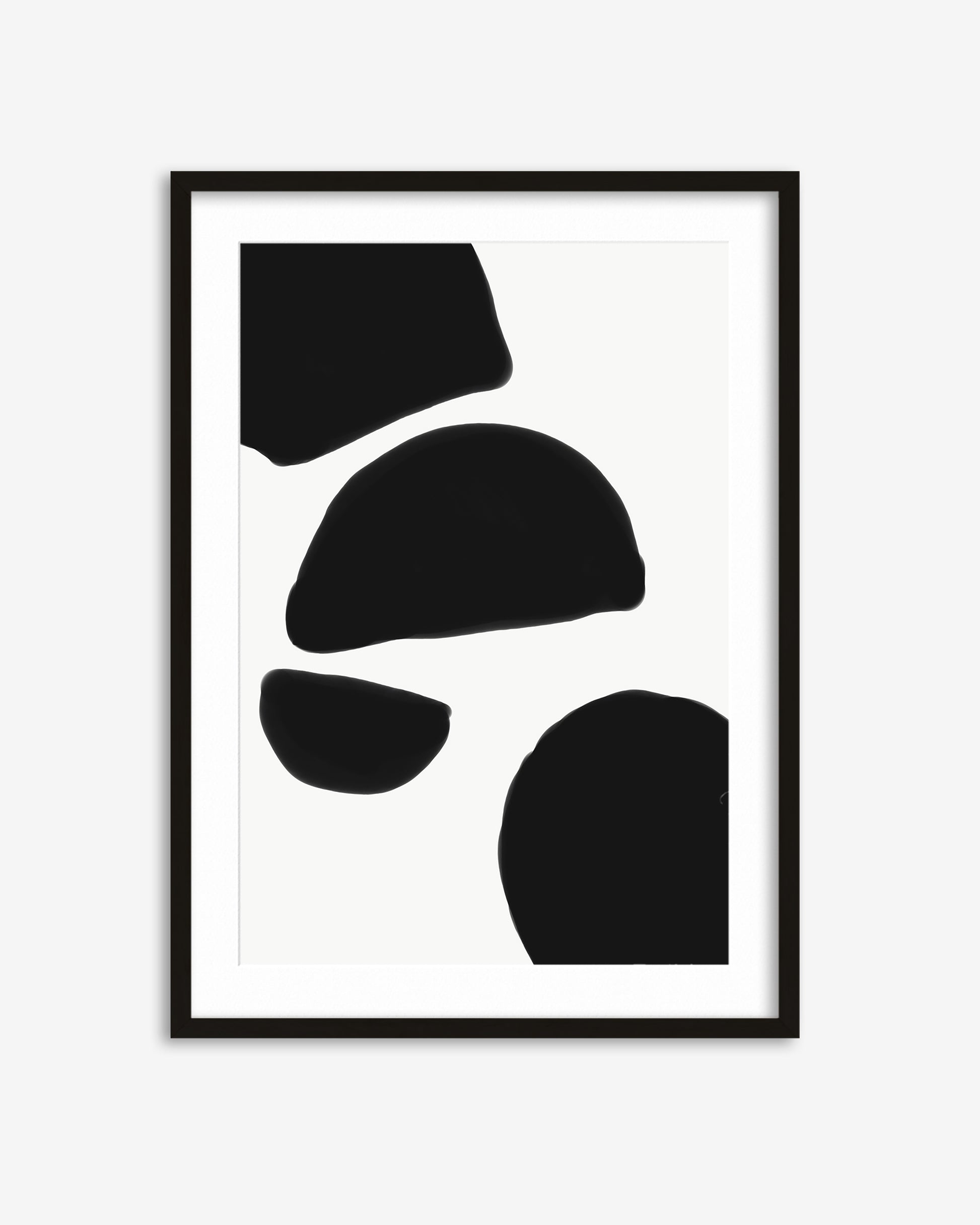 Framed abstract art with black shapes on a white background