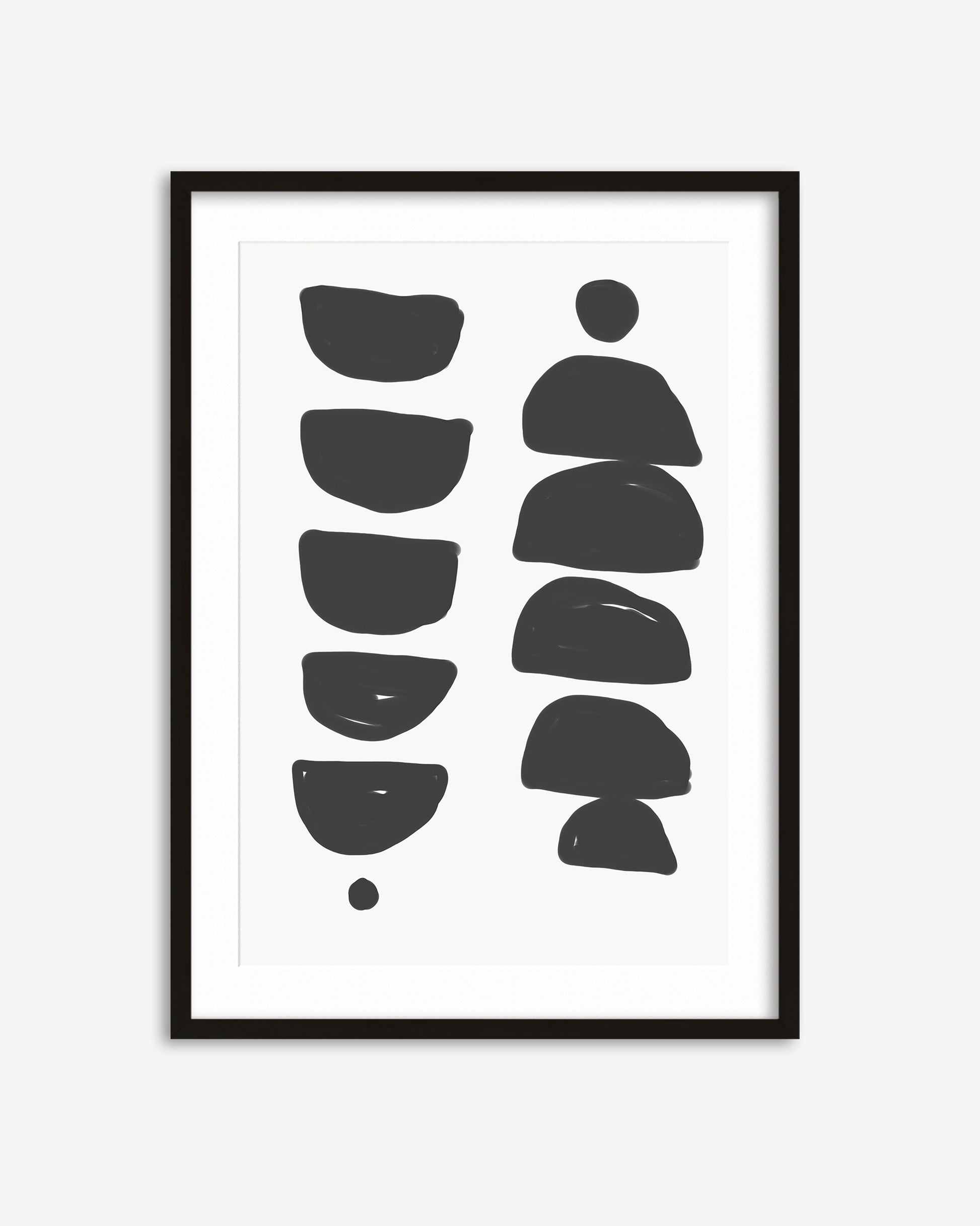 Framed artwork with black abstract shapes on a white background