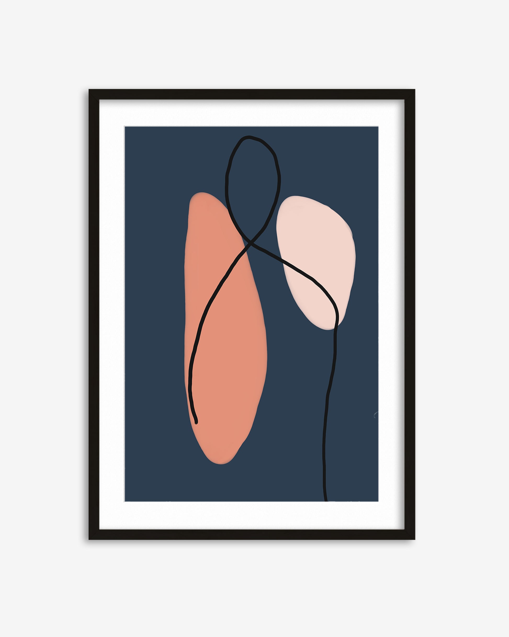 Framed abstract art print with pink and peach shapes on a dark blue background