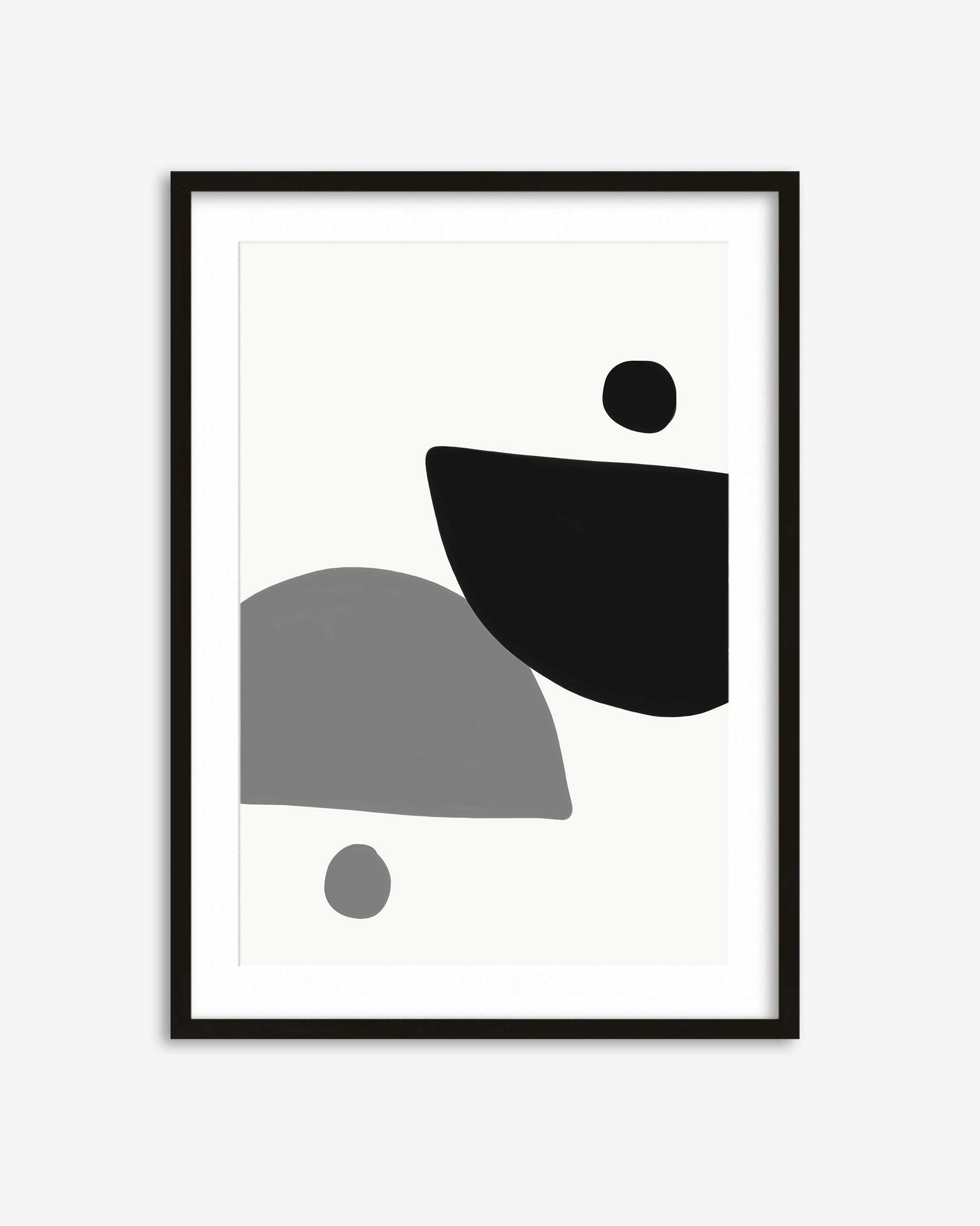 Framed abstract art print with black and gray shapes on a white background