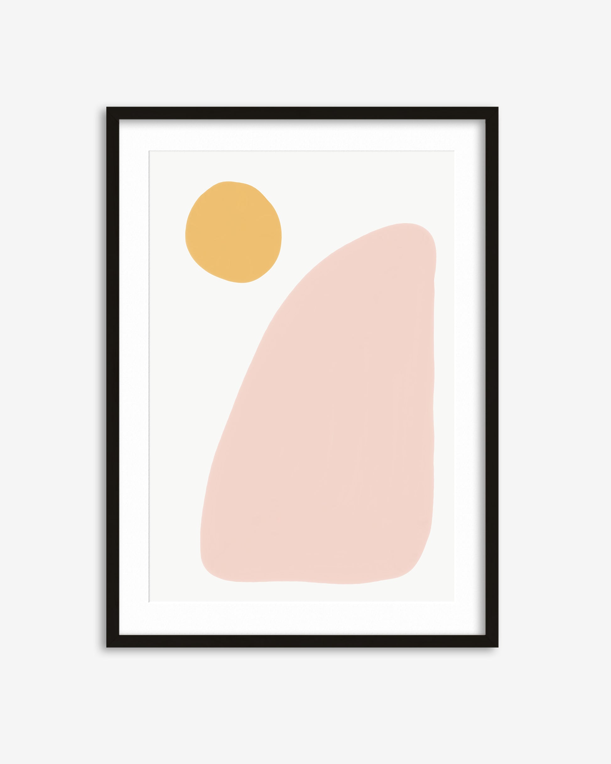 Framed abstract art print with a yellow circle and pink shape on a white background