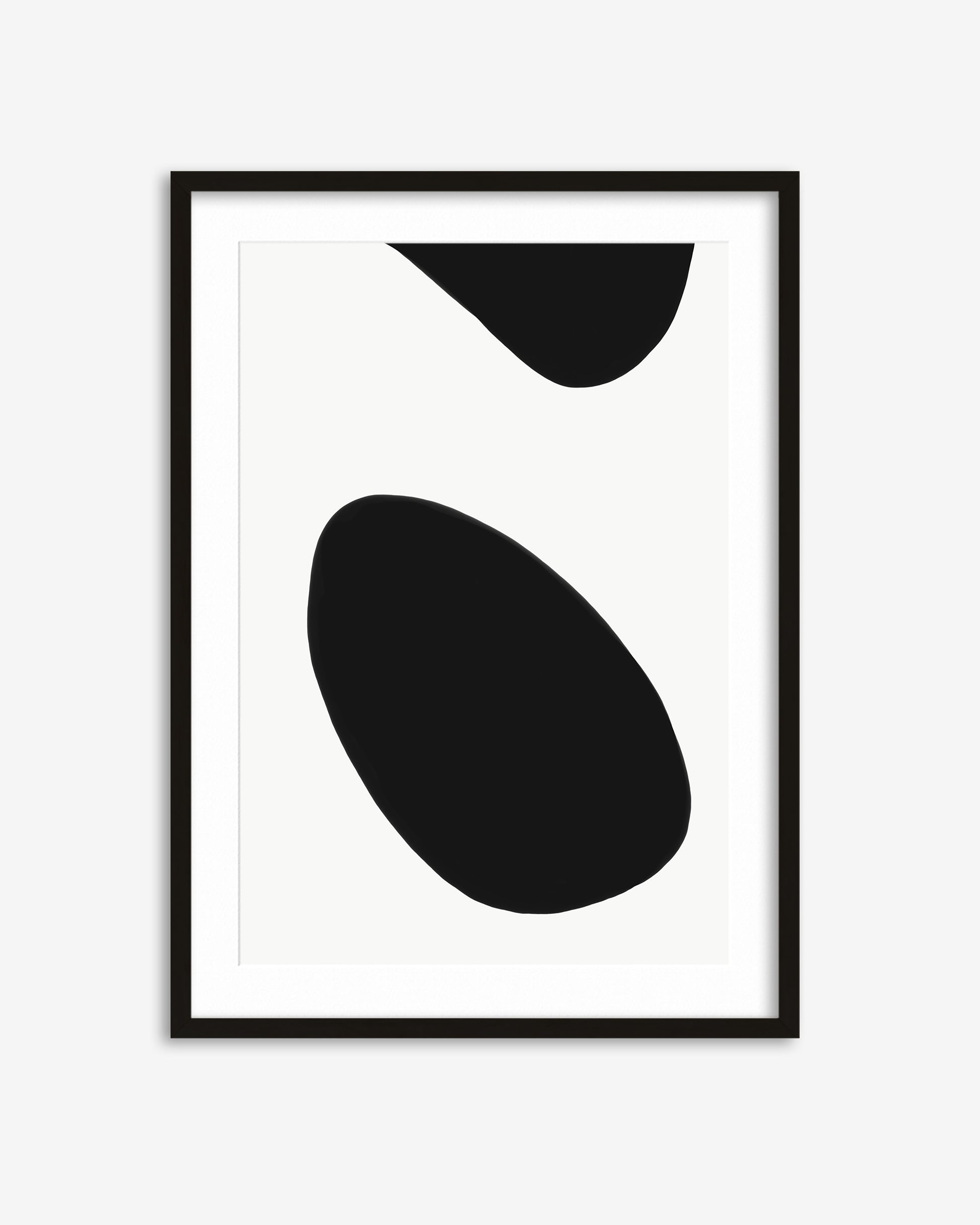 Framed abstract art print with black shapes on a white background