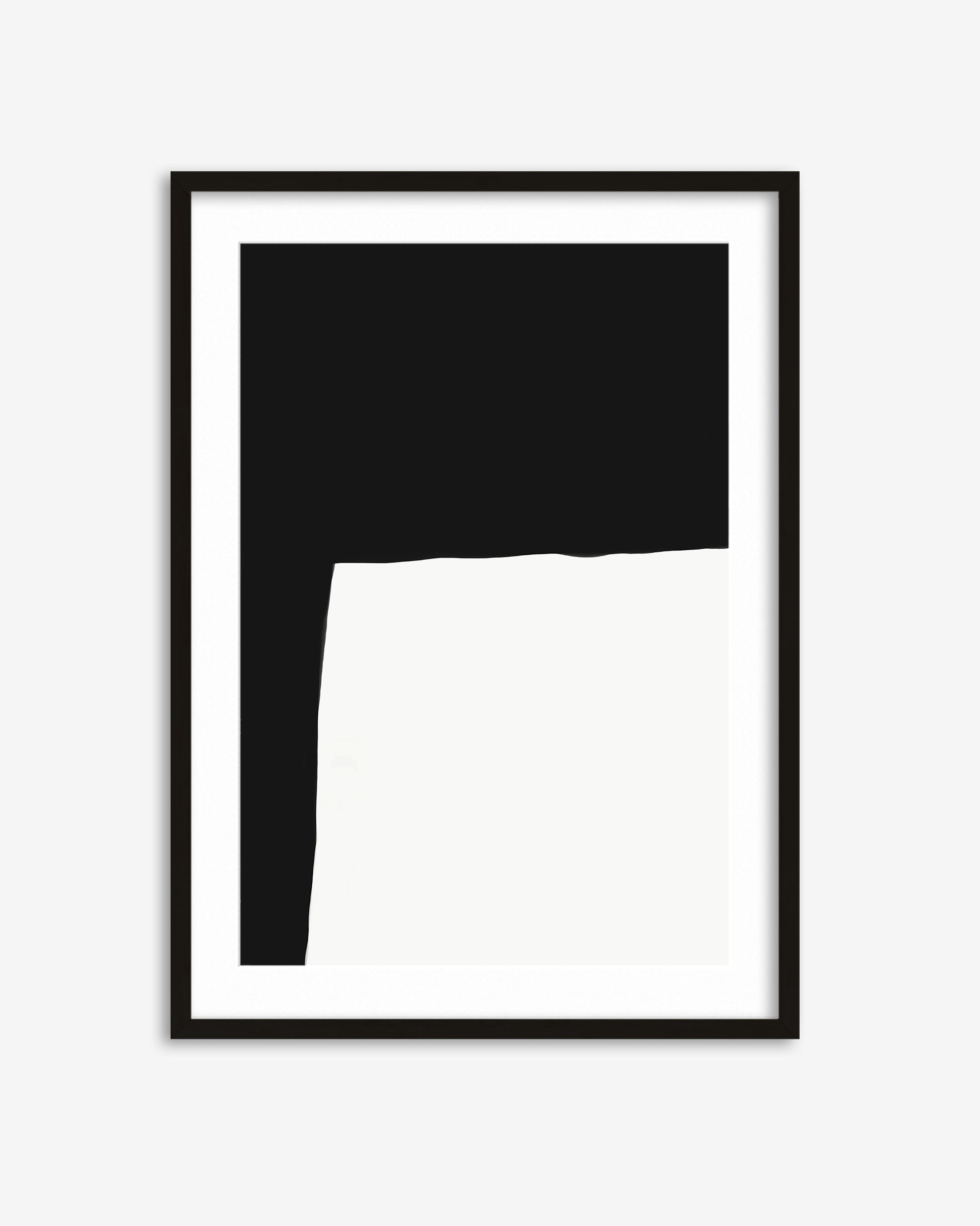 Framed black and white abstract art piece on a white background