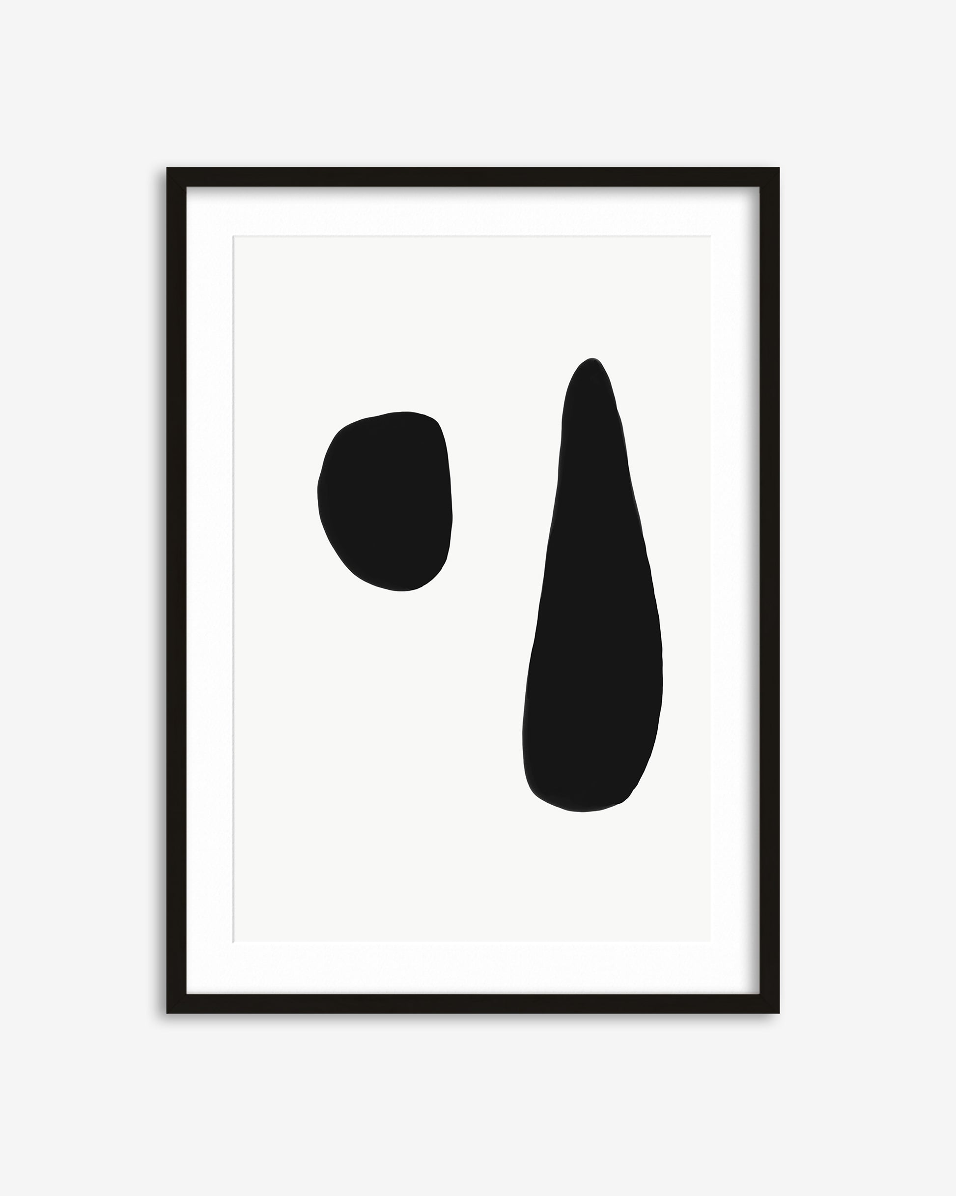 Framed abstract art print with two black shapes on a white background