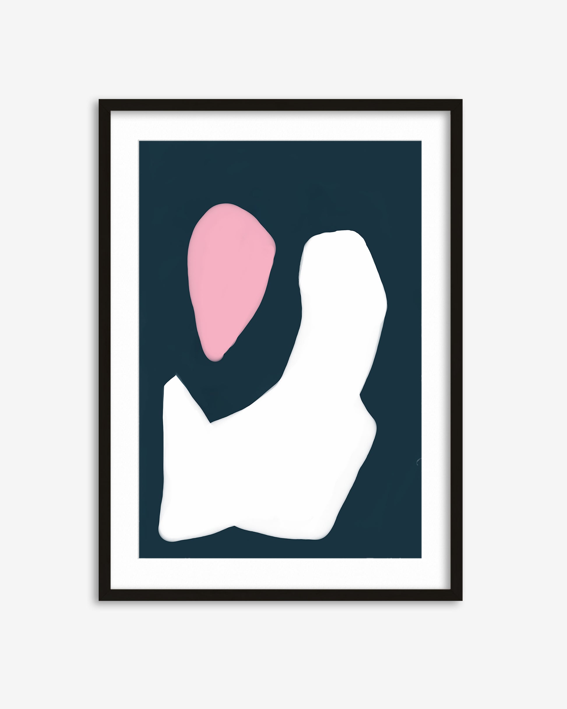 Framed abstract art print with pink and white shapes on a dark blue background