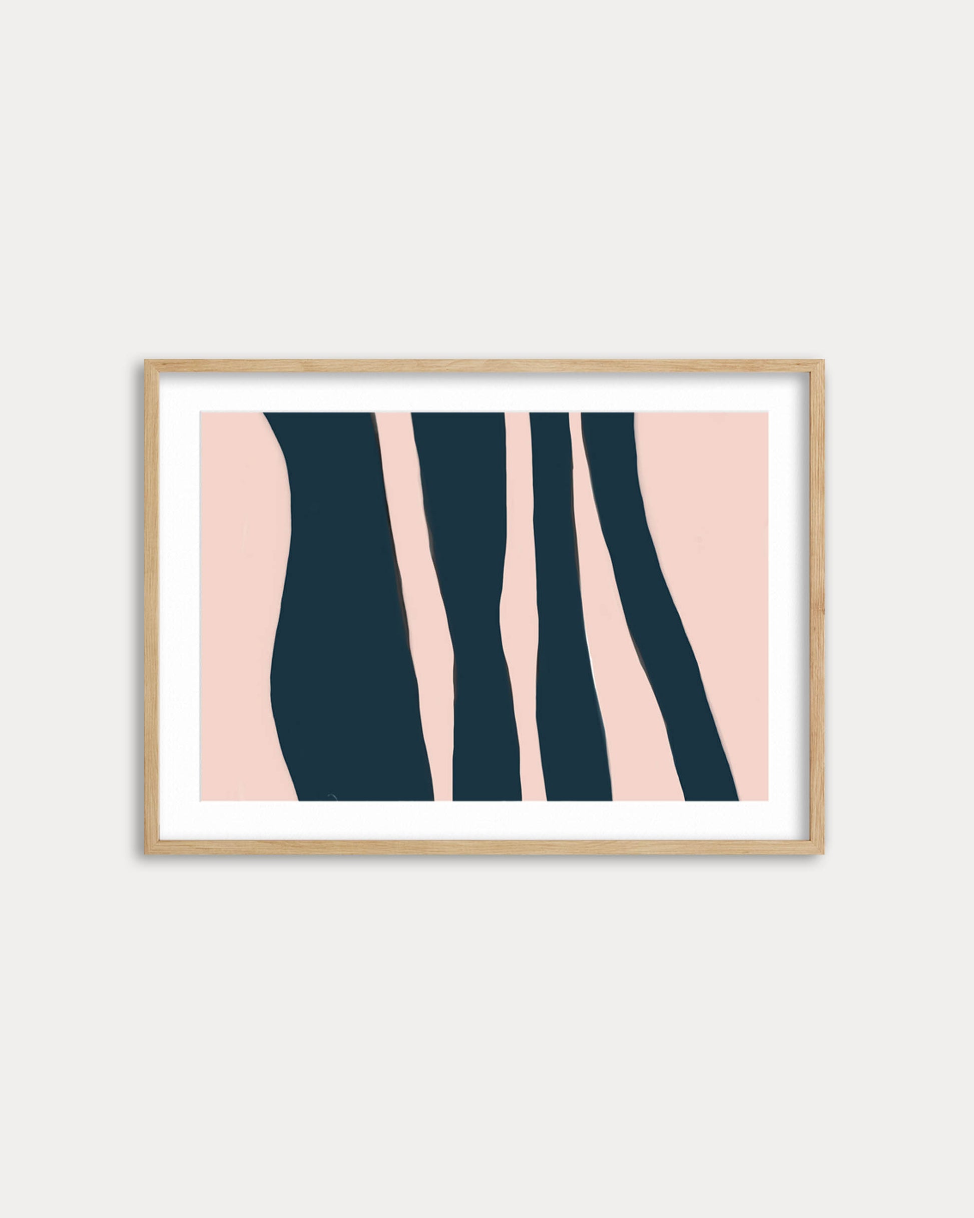 Framed abstract art print with pink and navy design on a white wall