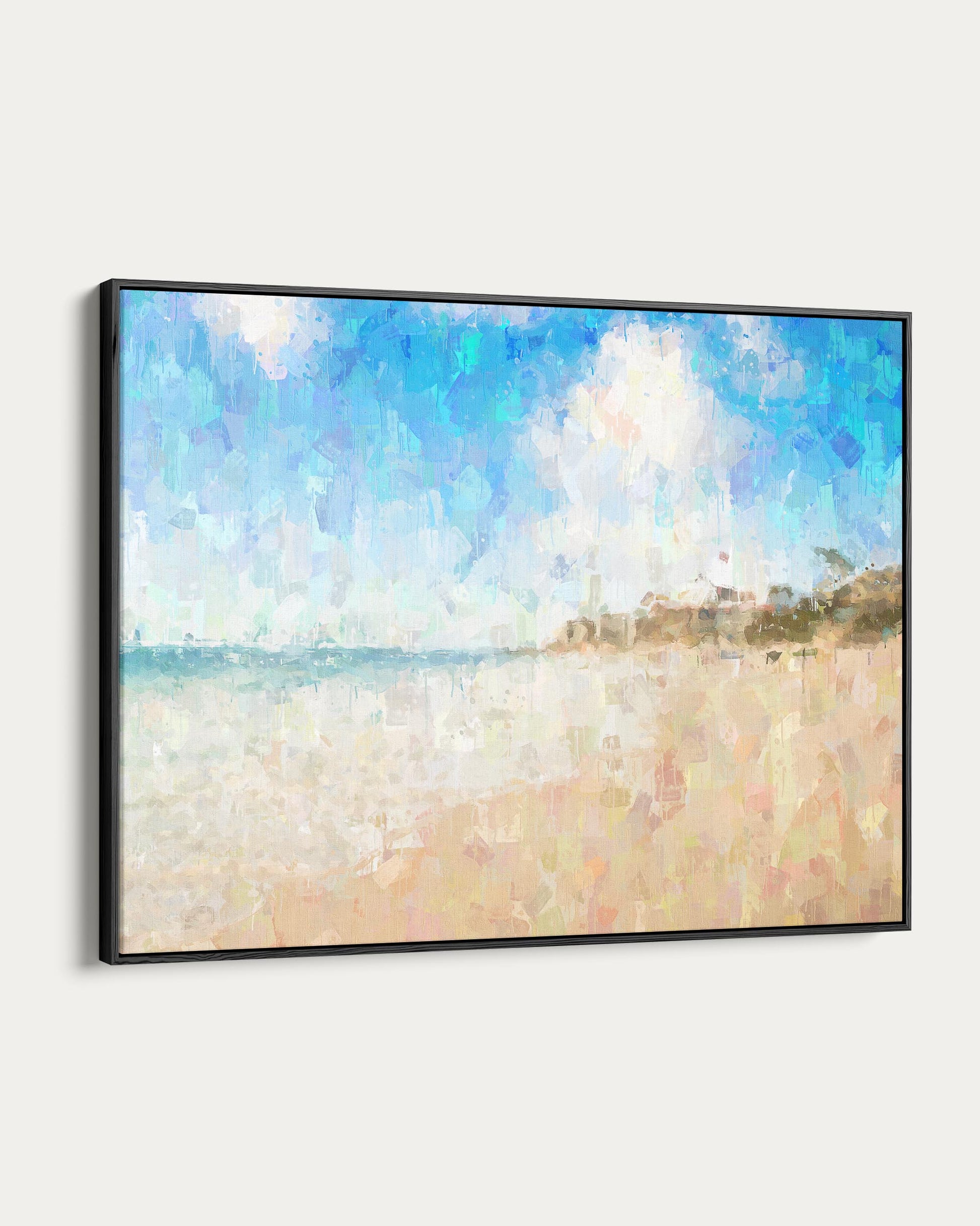 Framed artwork of a beach scene with blue sky and white clouds.