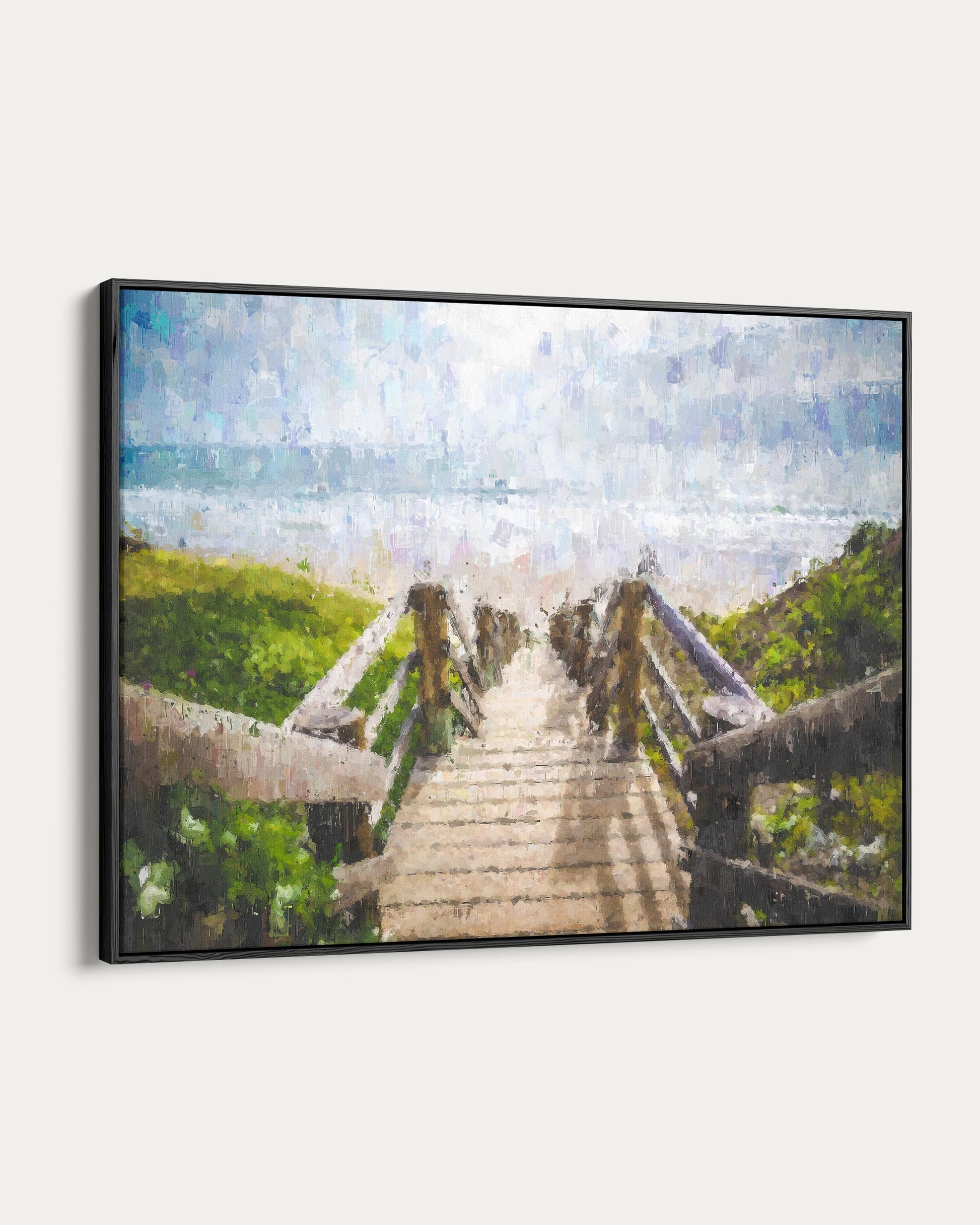 Framed artwork of a wooden staircase leading to a beach with a blue sky.