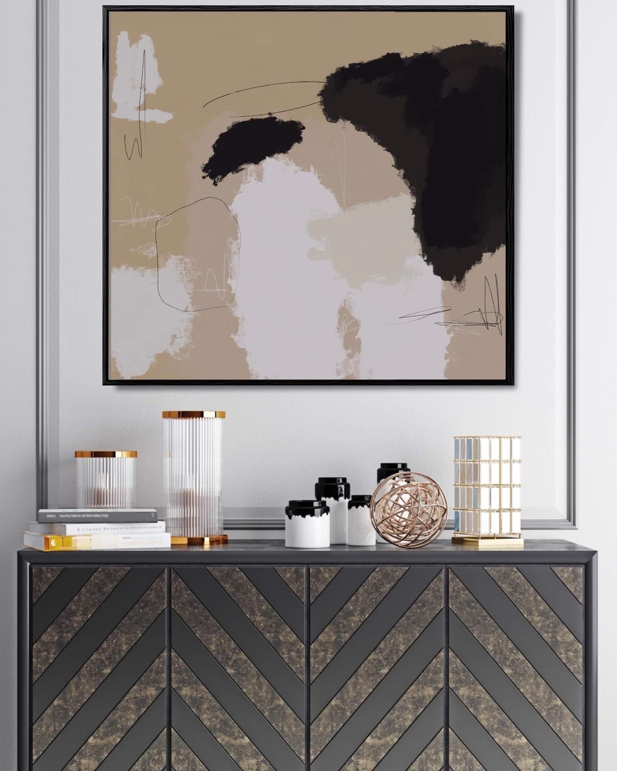 Abstract art piece on a wall above a decorative console table with various items.