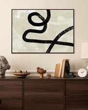 Abstract black line art on a light background in a modern interior setting.