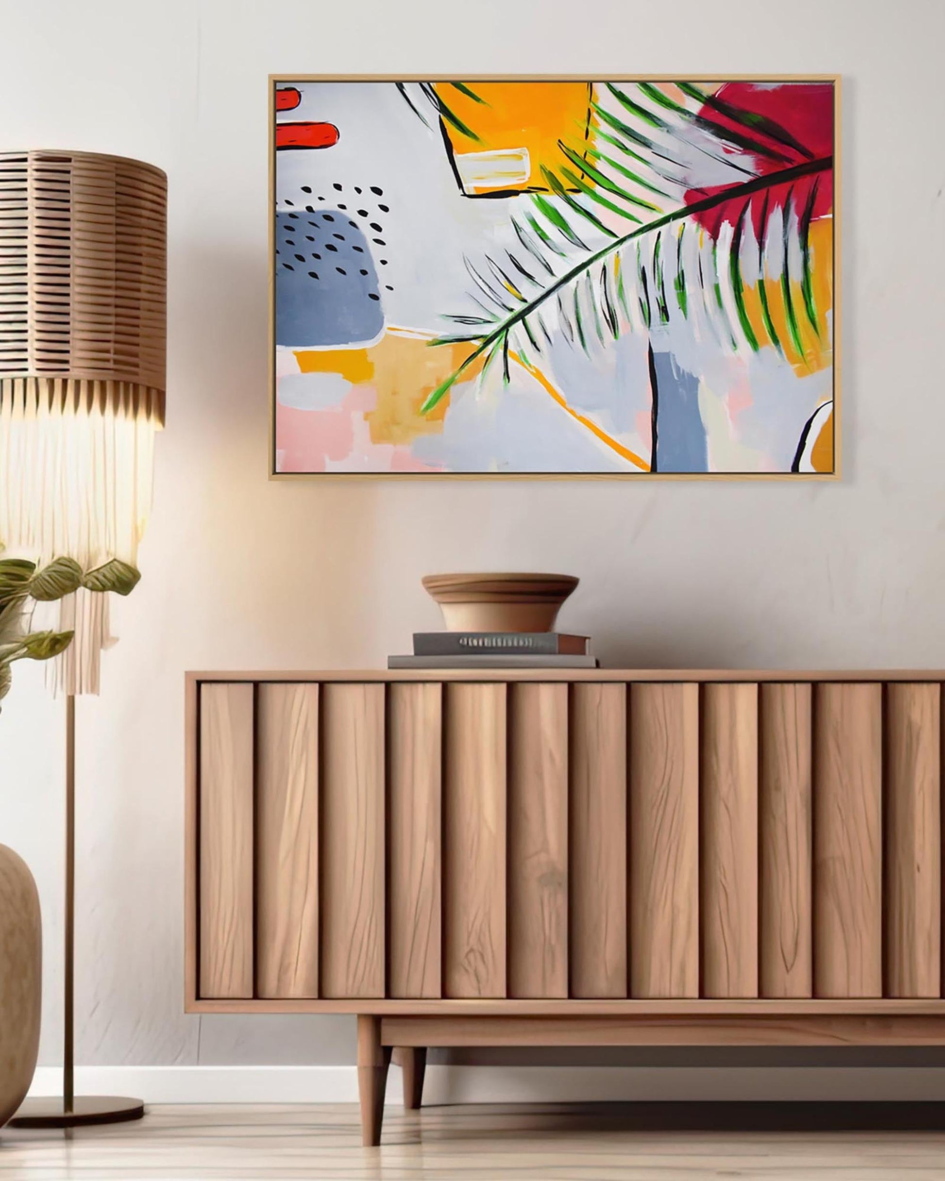 Wooden sideboard with abstract art above it in a room setting