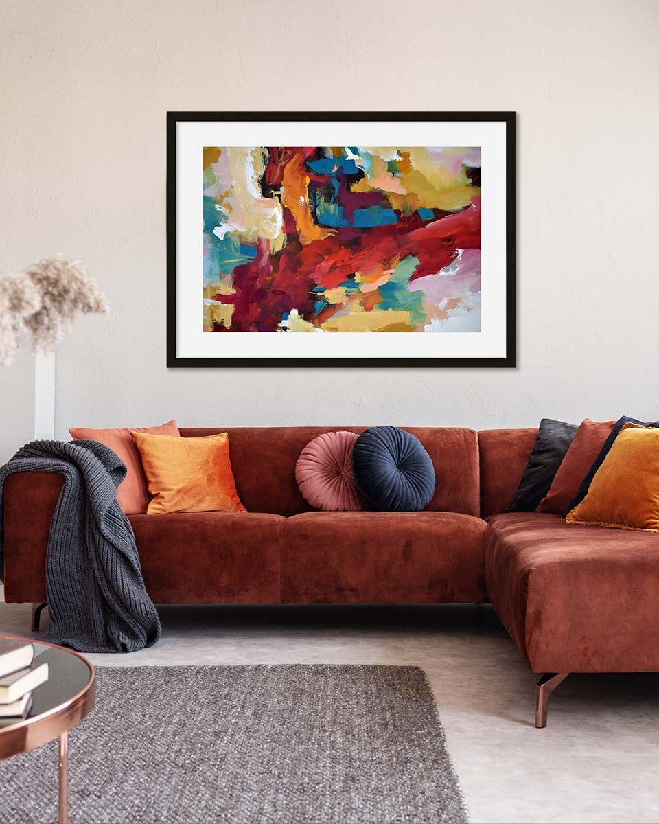 Living room with a brown sectional sofa, colorful pillows, and a abstract painting on the wall.