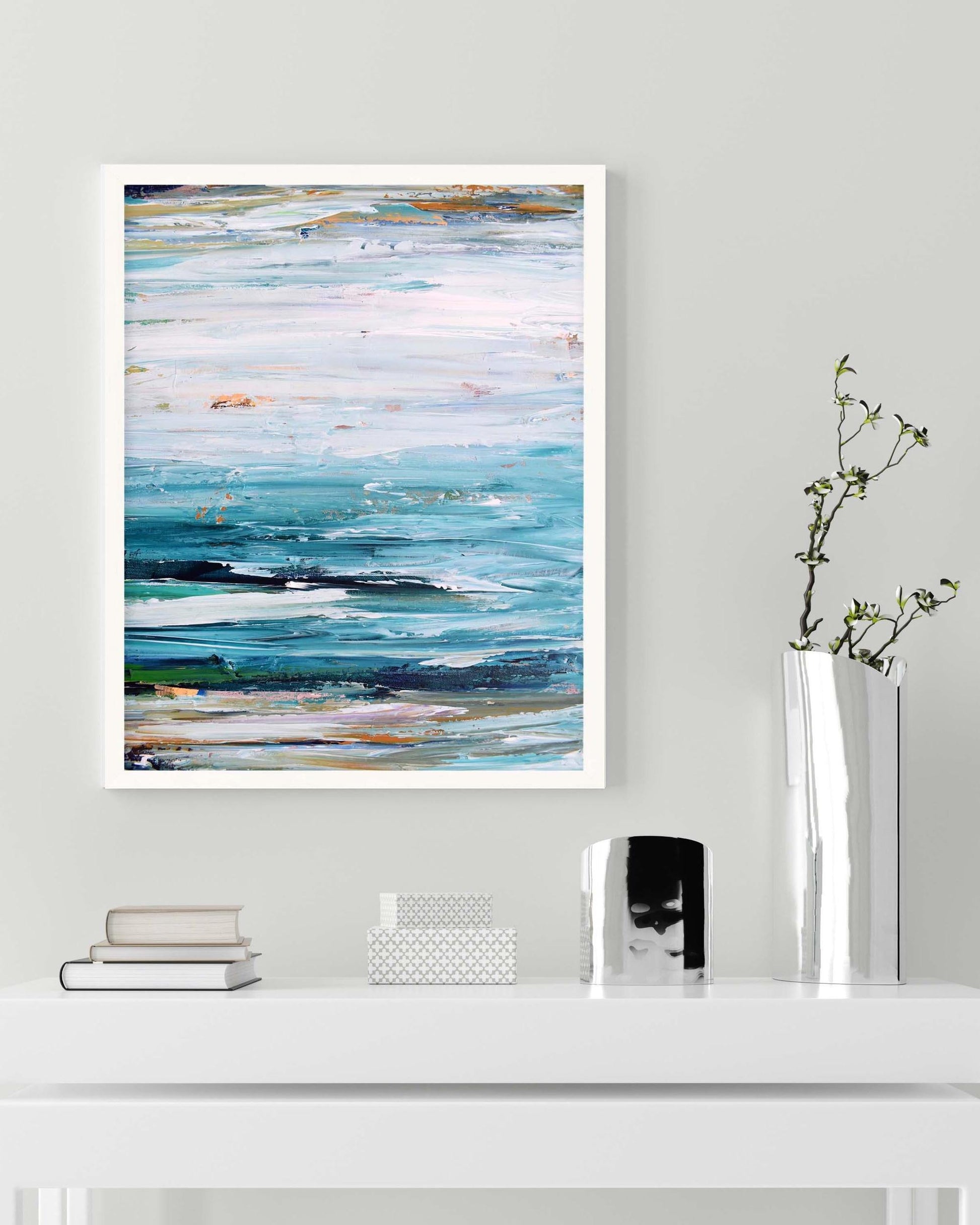 Abstract art print on a wall above a white shelf with decorative items.