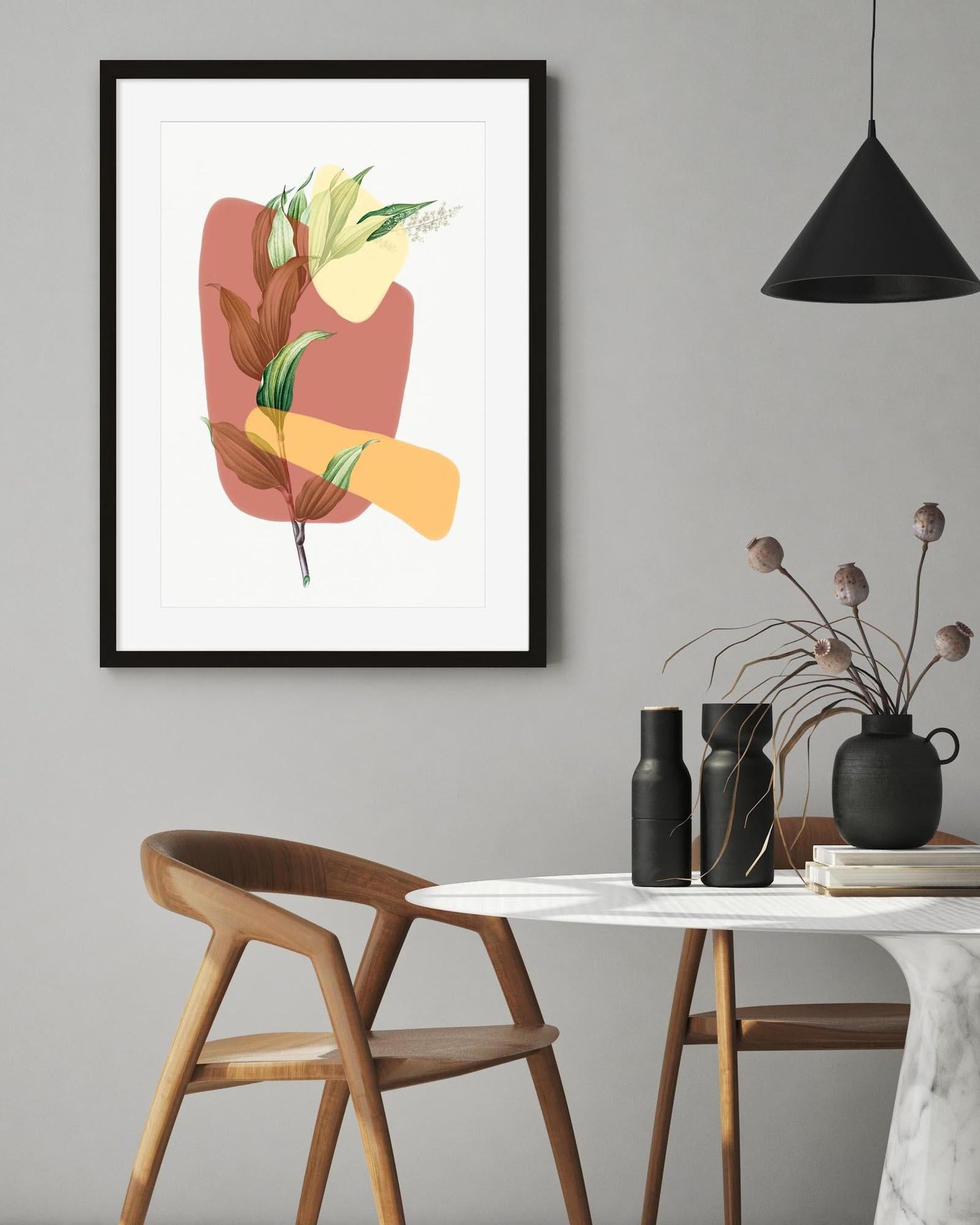 Framed abstract art piece on a wall above a wooden chair and table with decorative items.