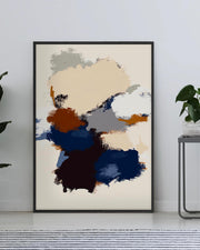 Abstract art print in a black frame on a wall with plants and a table below.