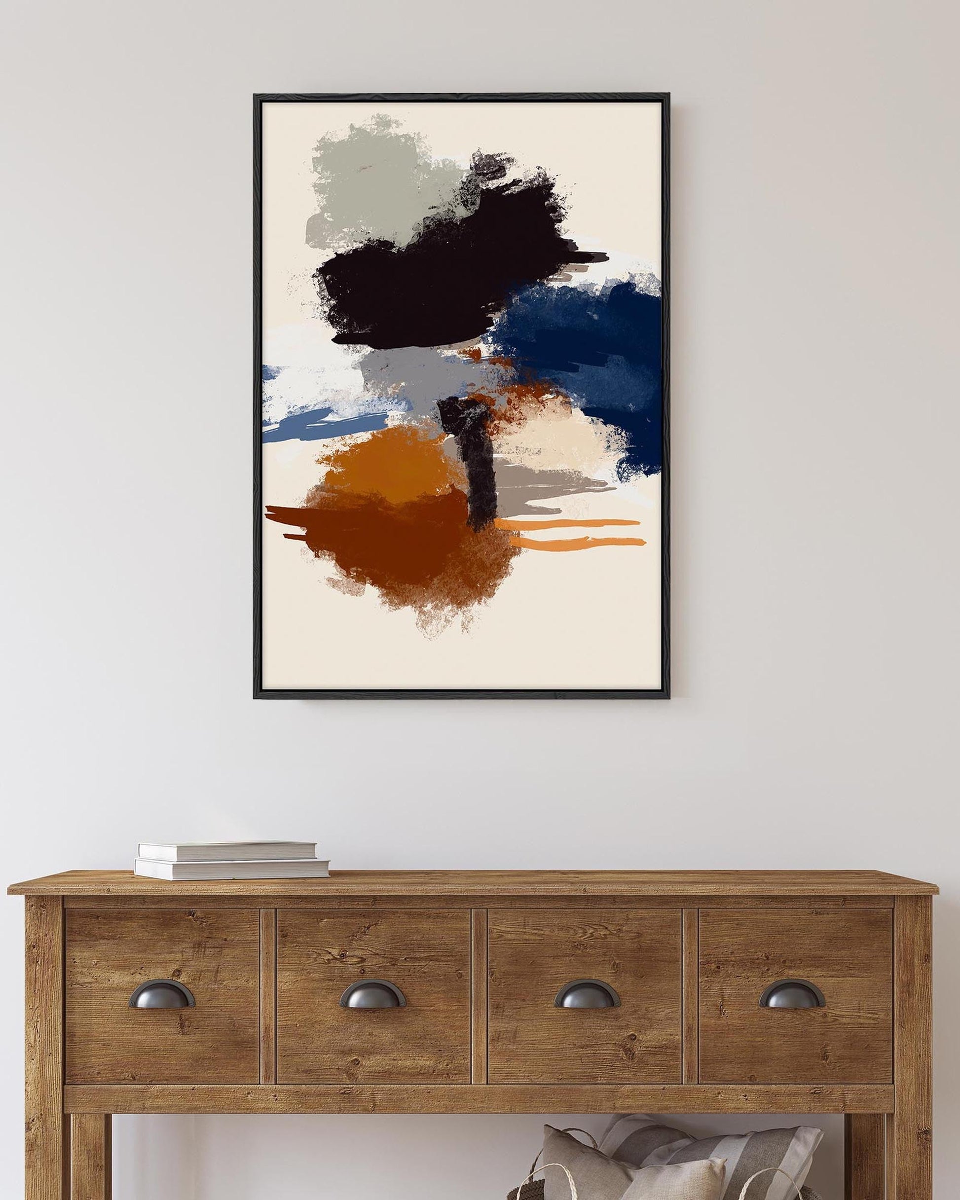 Abstract art print on a wall above a wooden console table.