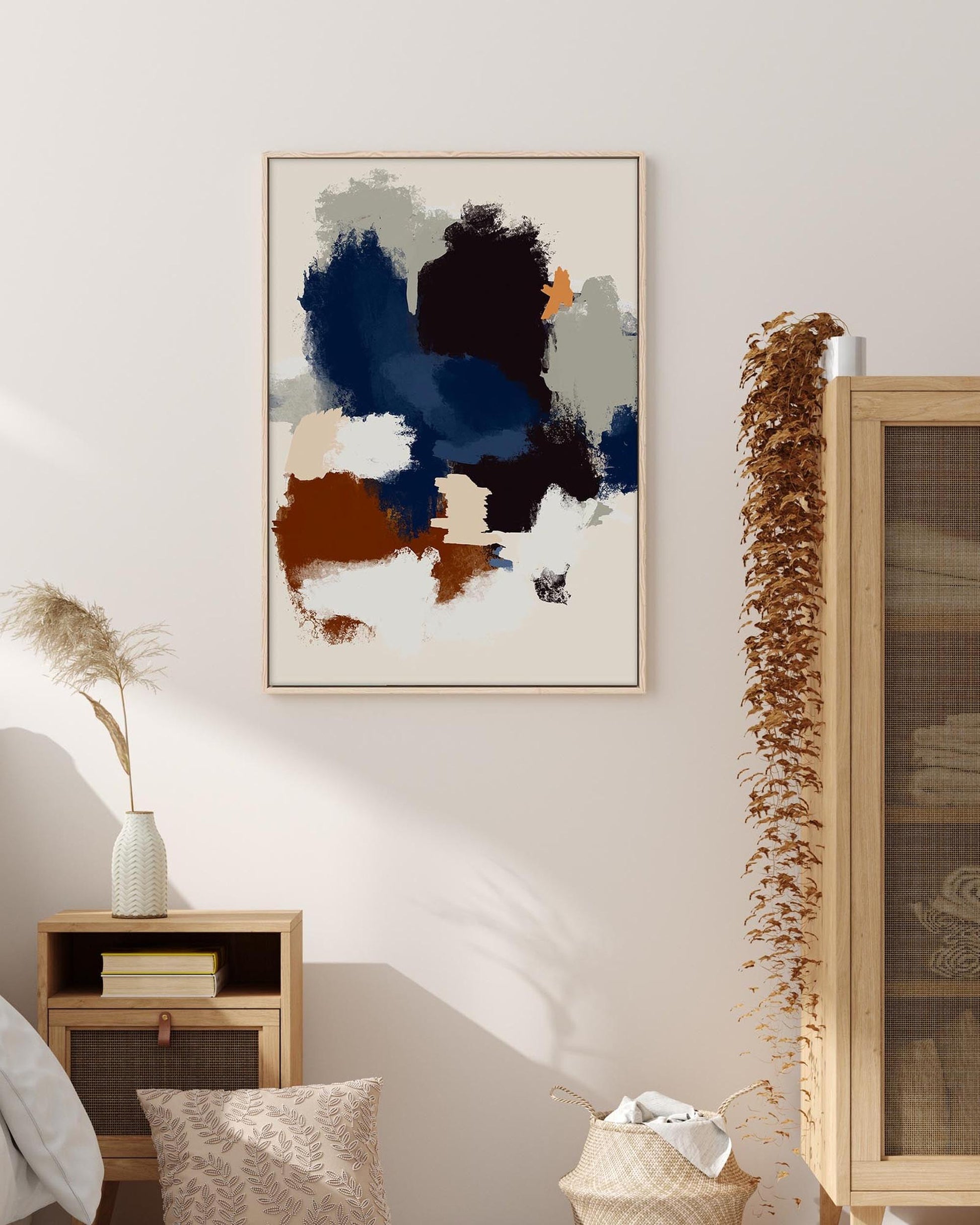 Abstract art piece on a wall in a room with wooden furniture and decor.