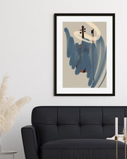 Framed abstract art piece on a wall above a black sofa
