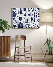 Modern interior with abstract art, wooden furniture, and plants.
