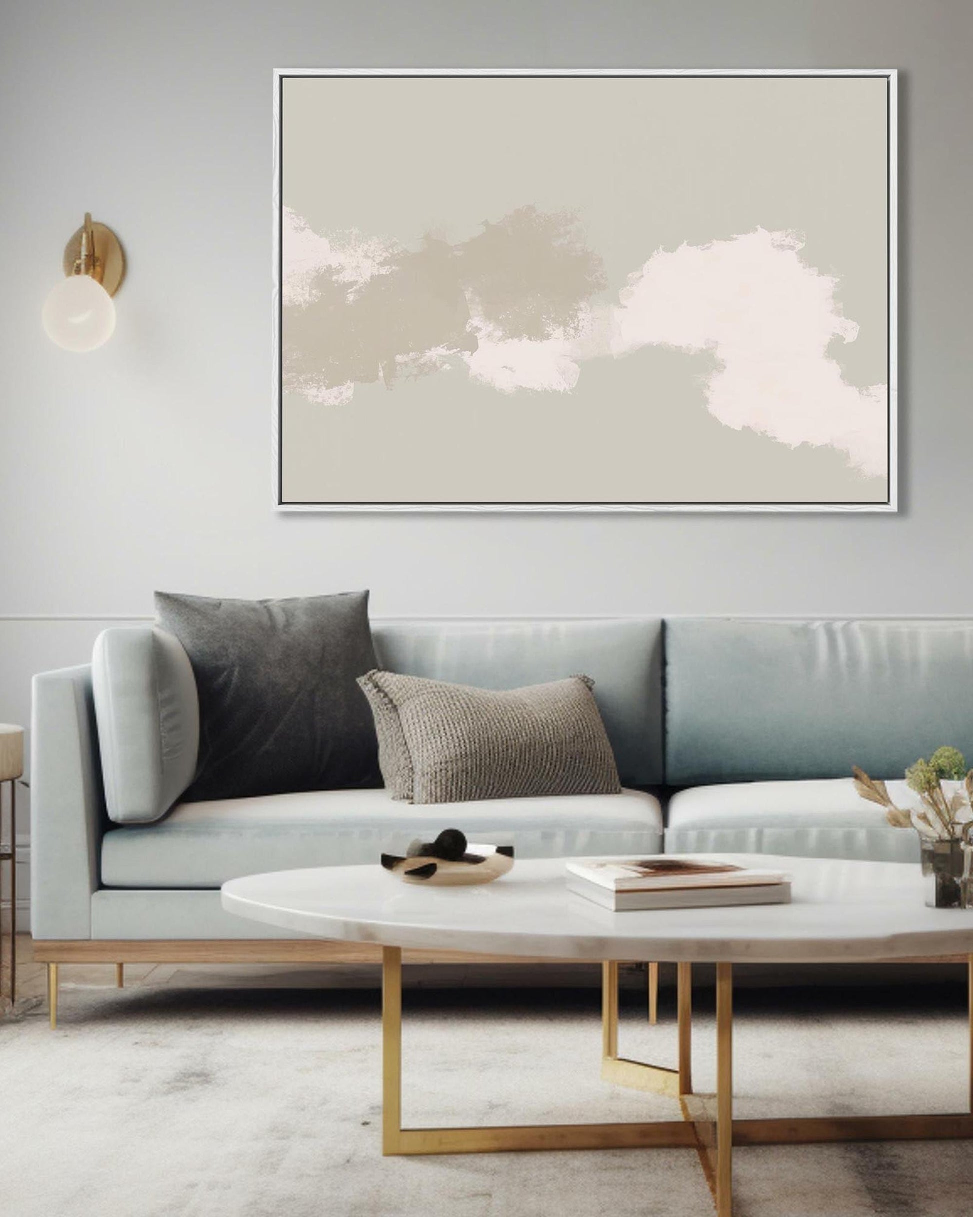 Modern living room with a gray sofa, coffee table, and abstract wall art.