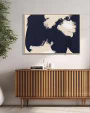 Modern interior with wooden sideboard, abstract art, and plant