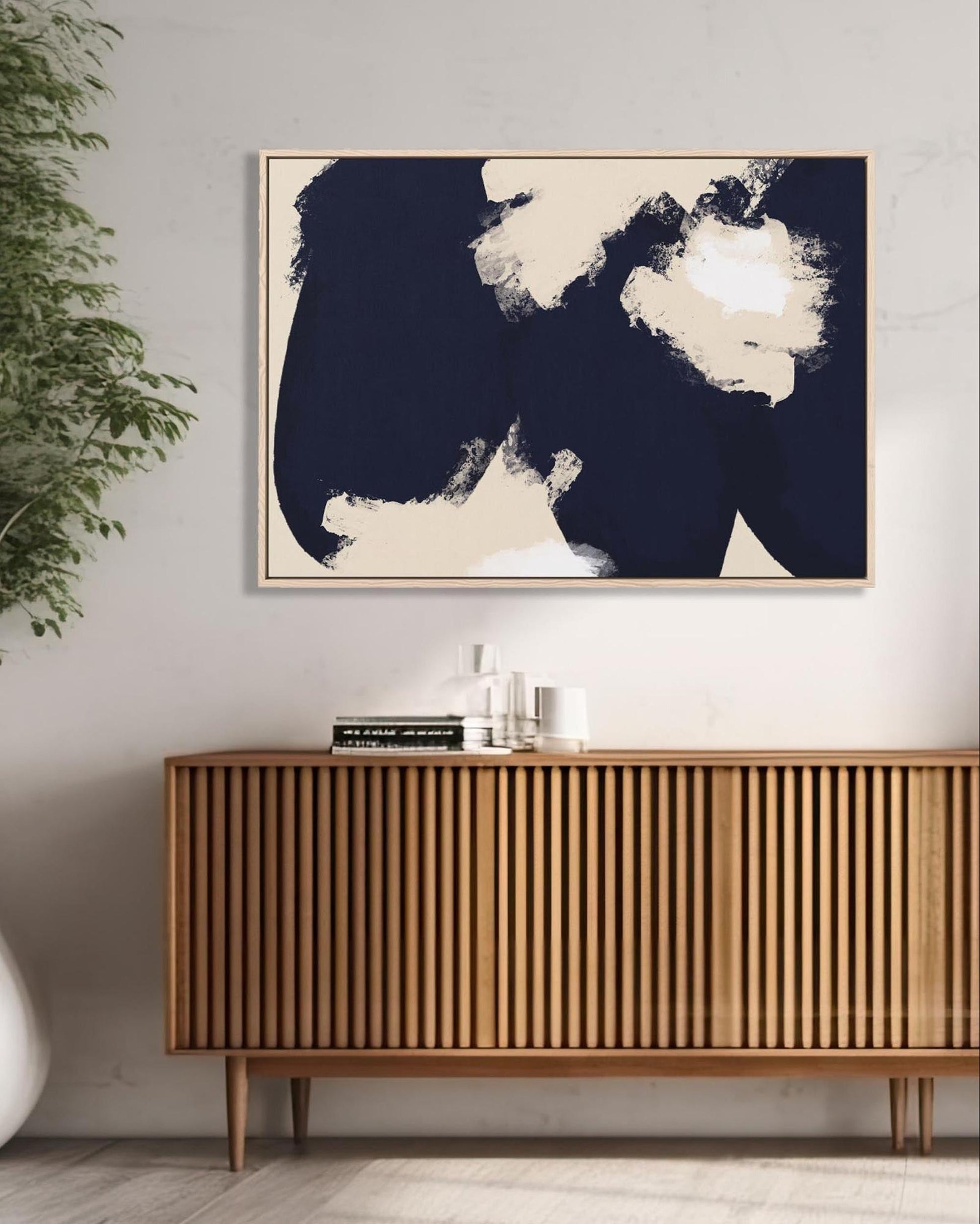 Modern interior with wooden sideboard, abstract art, and plant