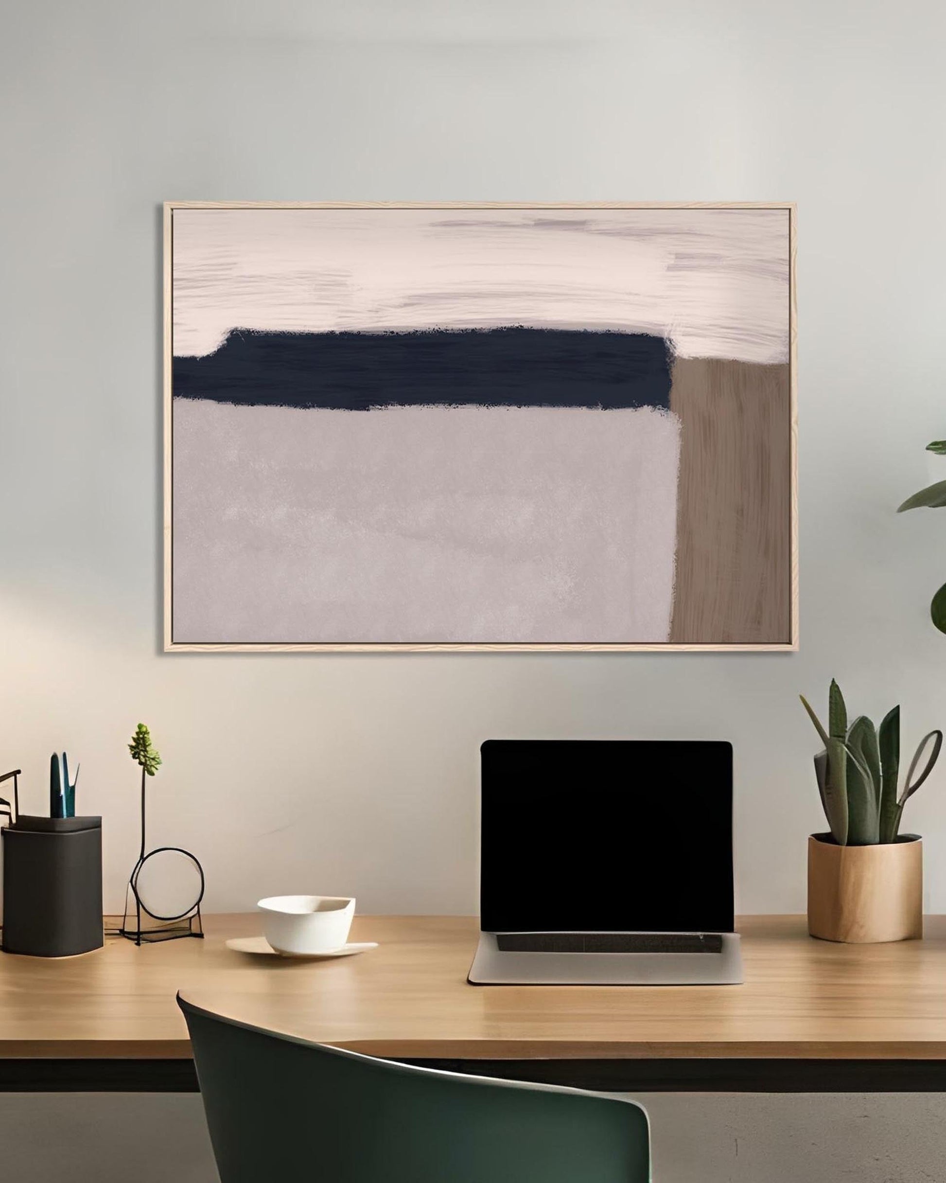 Modern office desk with abstract art on the wall
