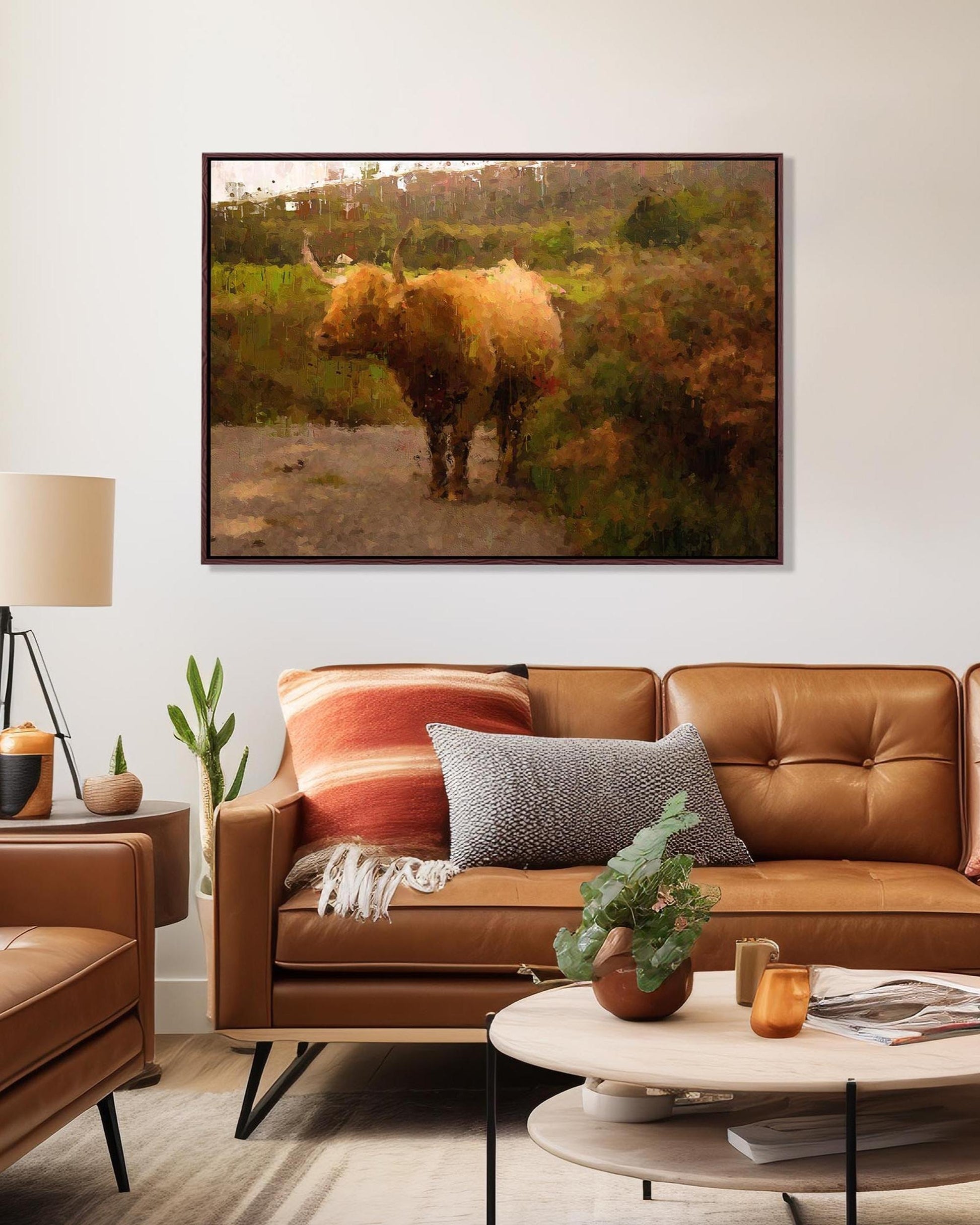 Living room with brown leather sofa, decorative pillows, and a framed picture of a rhinoceros on the wall.