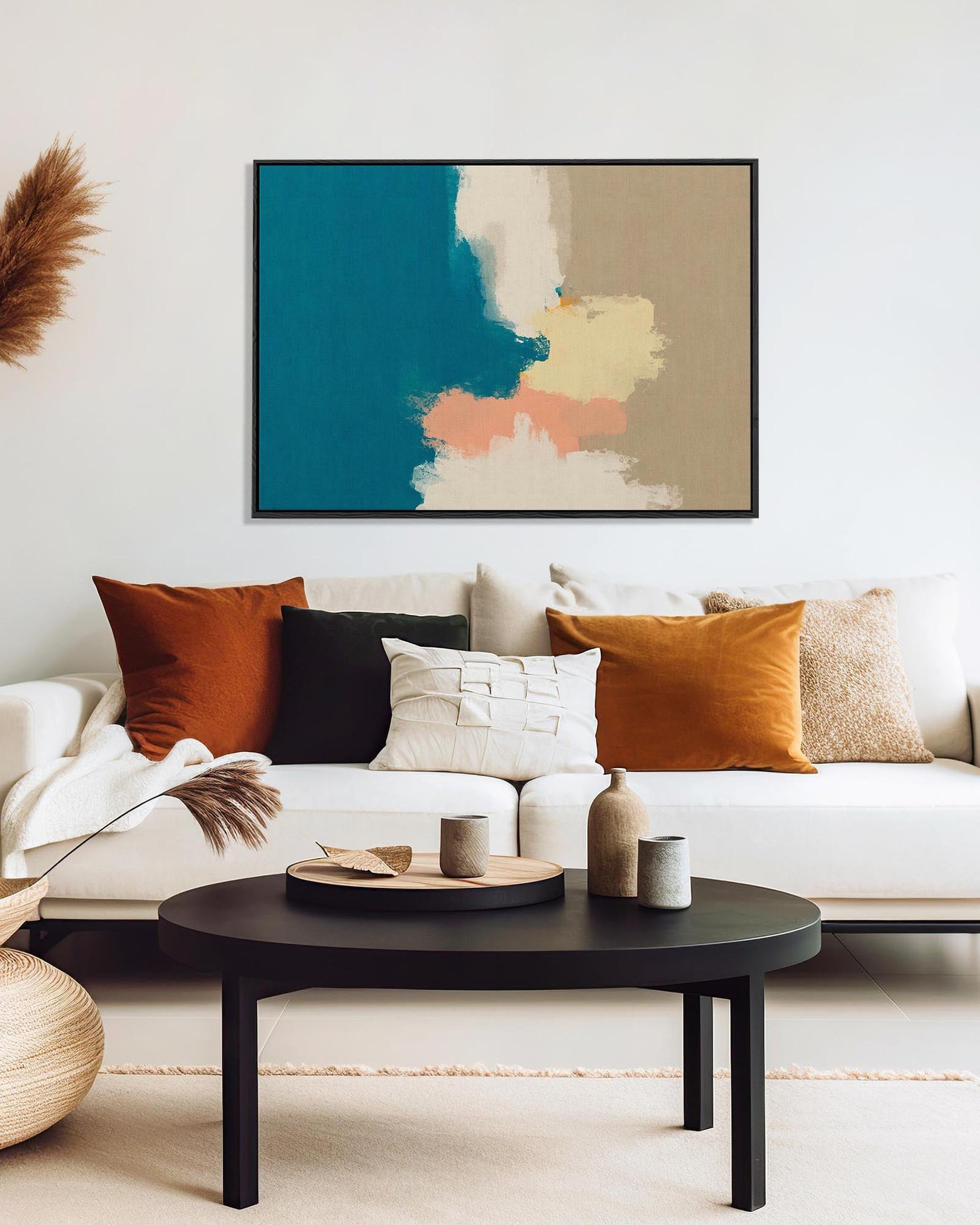 Modern living room with a white sofa, colorful pillows, and a abstract painting on the wall.