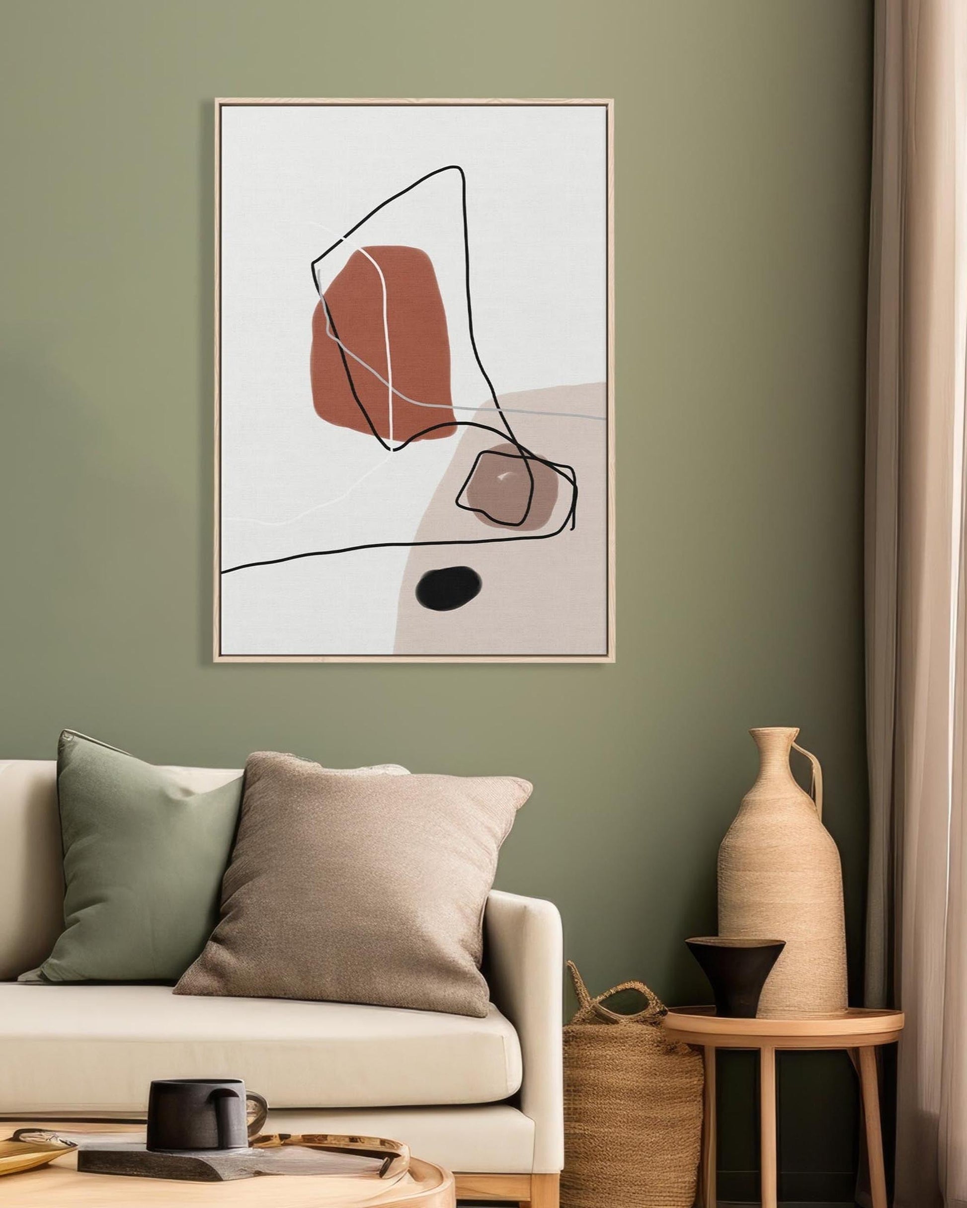 Living room with abstract art on the wall, beige sofa, and decorative items.