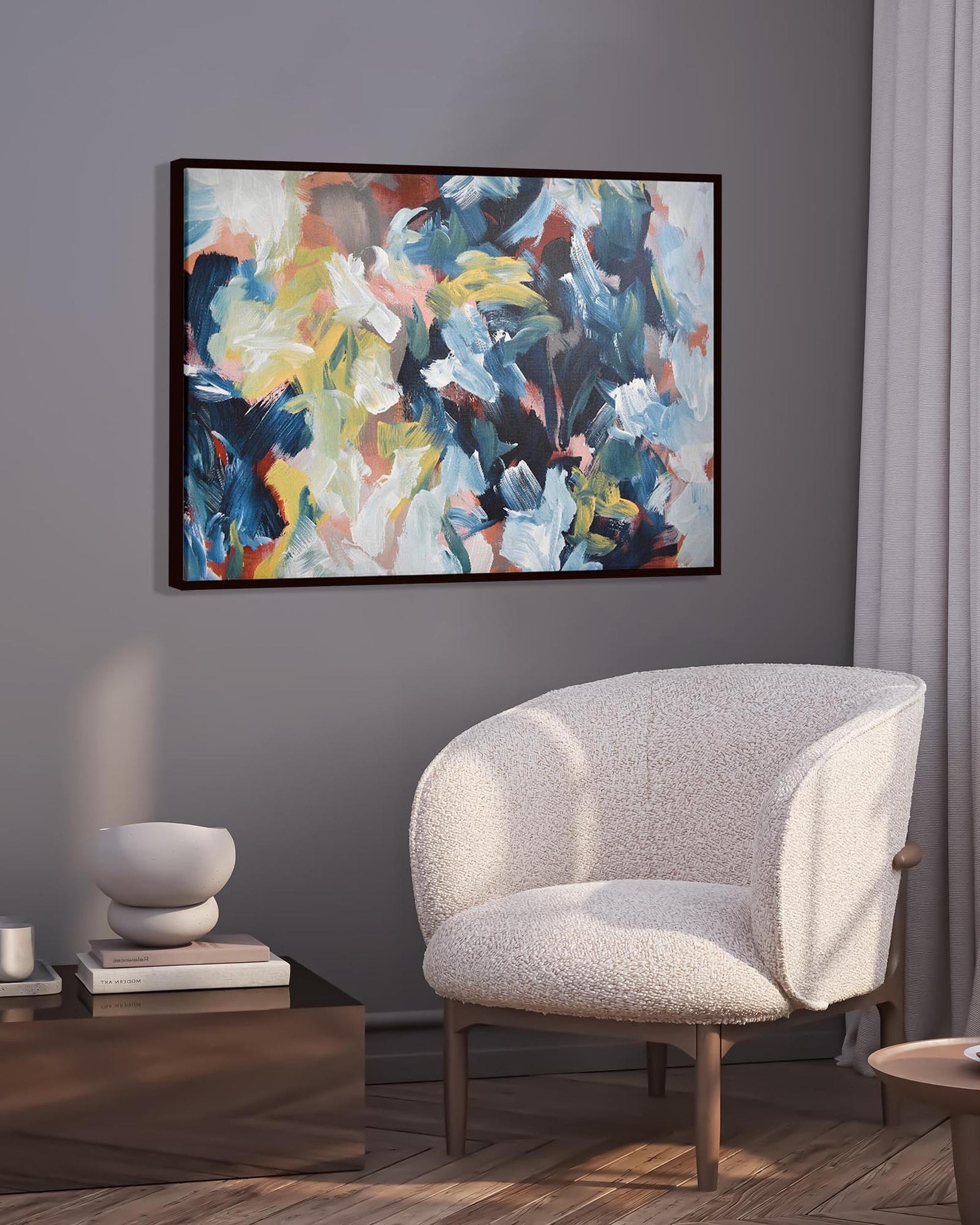 Modern living room with a gray armchair, abstract painting, and small table with a cup.