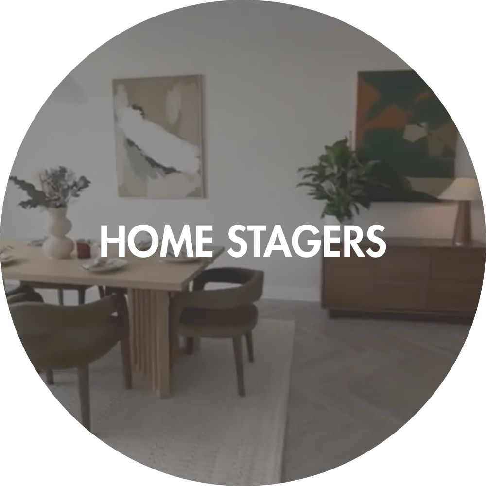 Dining room with table, chairs, modern large canvas wall art on wall and decor elements with 'HOME STAGERS' text overlay.