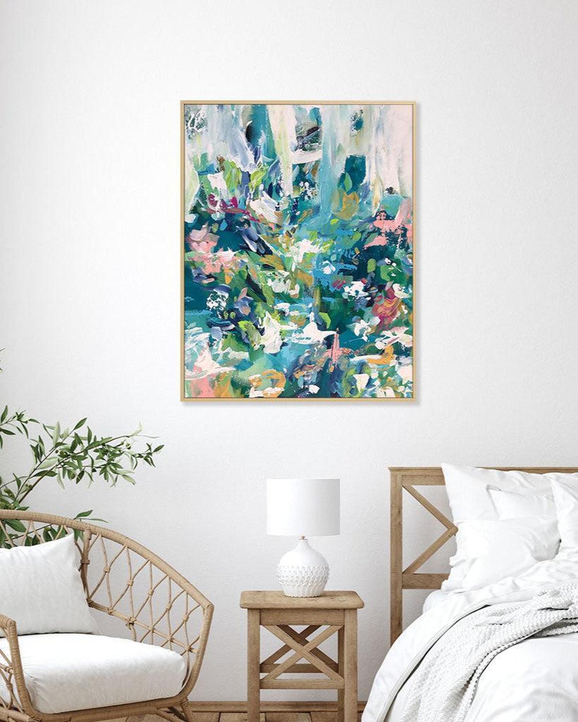 Abstract painting on a wall in a bedroom with a chair, nightstand, and bed.