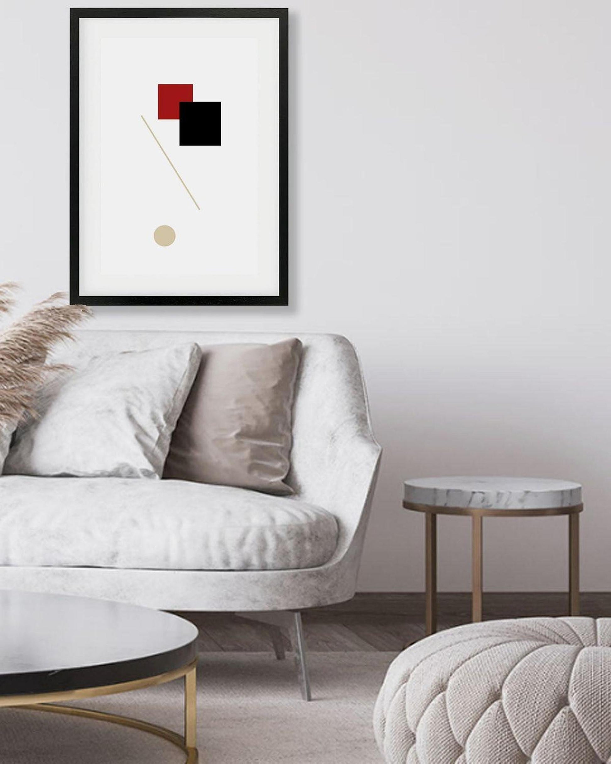 Modern living room with a white sofa, marble table, and abstract art on the wall.