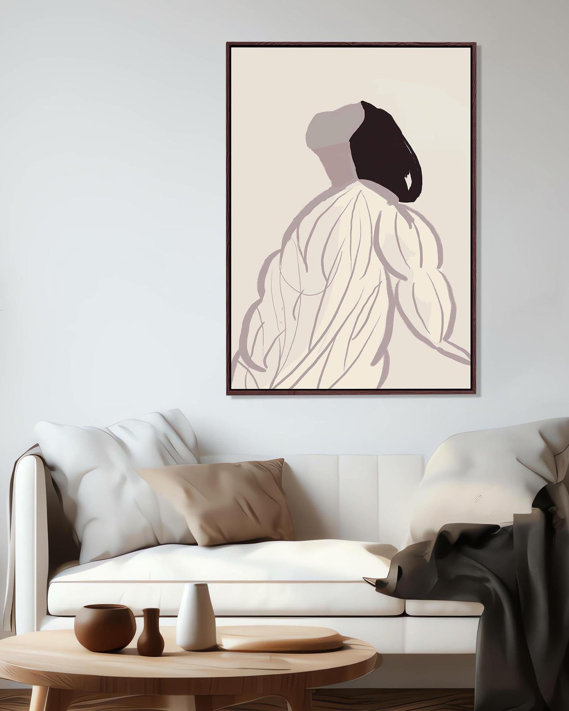 Modern living room with a white sofa, wooden coffee table, and abstract art on the wall.