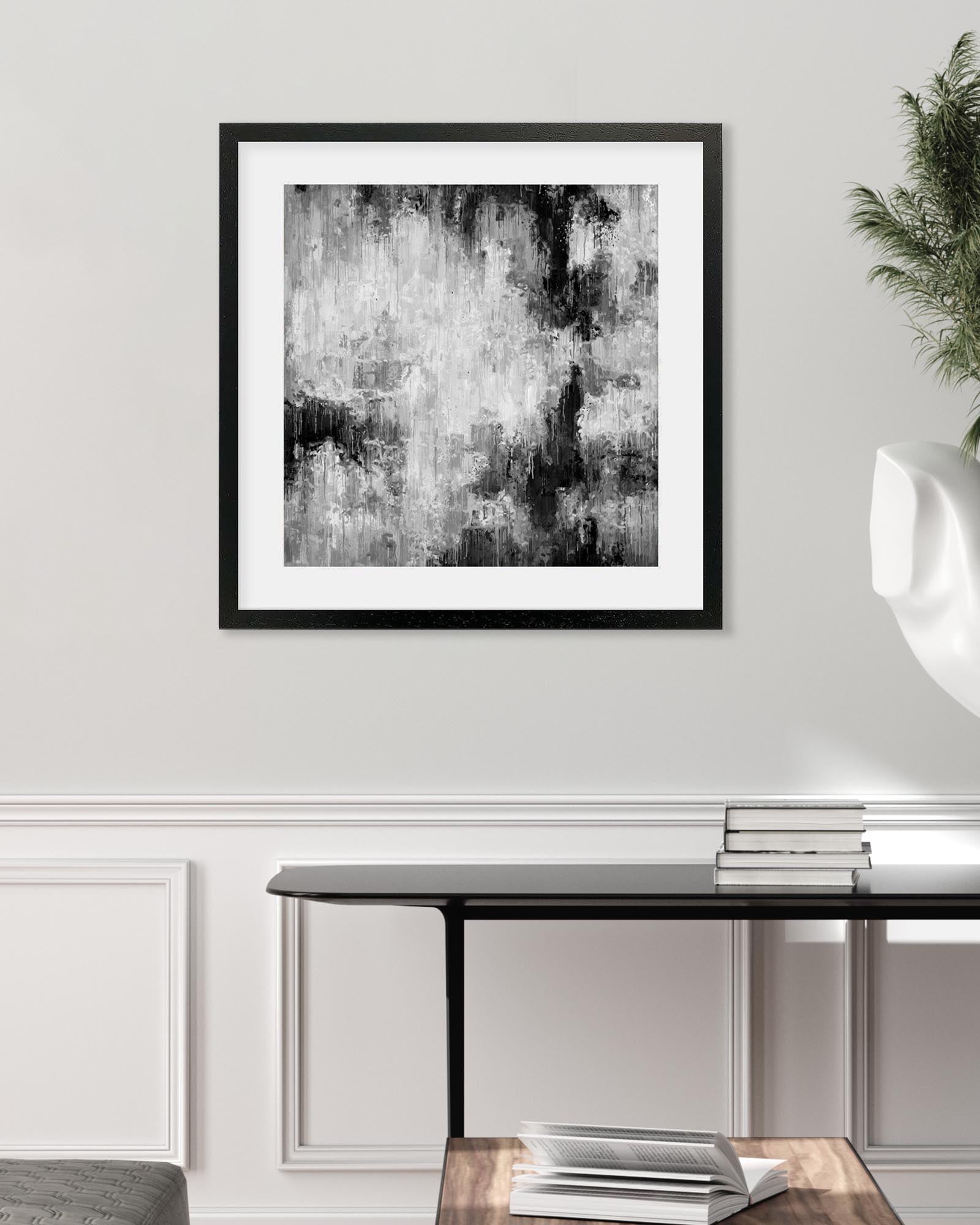 Framed black and white abstract art on a wall above a console table.