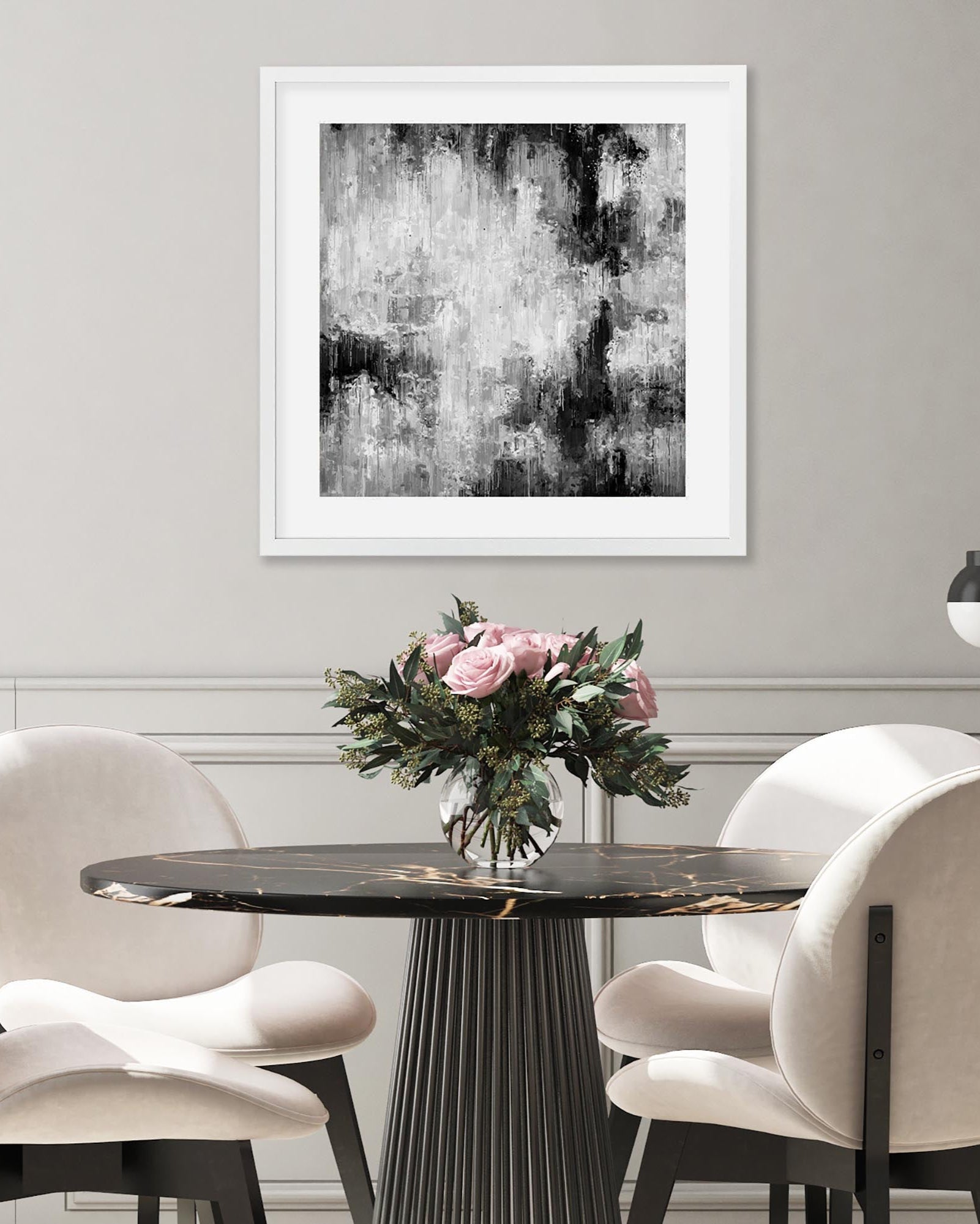 Dining room with a round table, chairs, and abstract art on the wall.