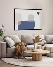 Modern living room with a gray sofa, wooden coffee table, and abstract art on the wall.