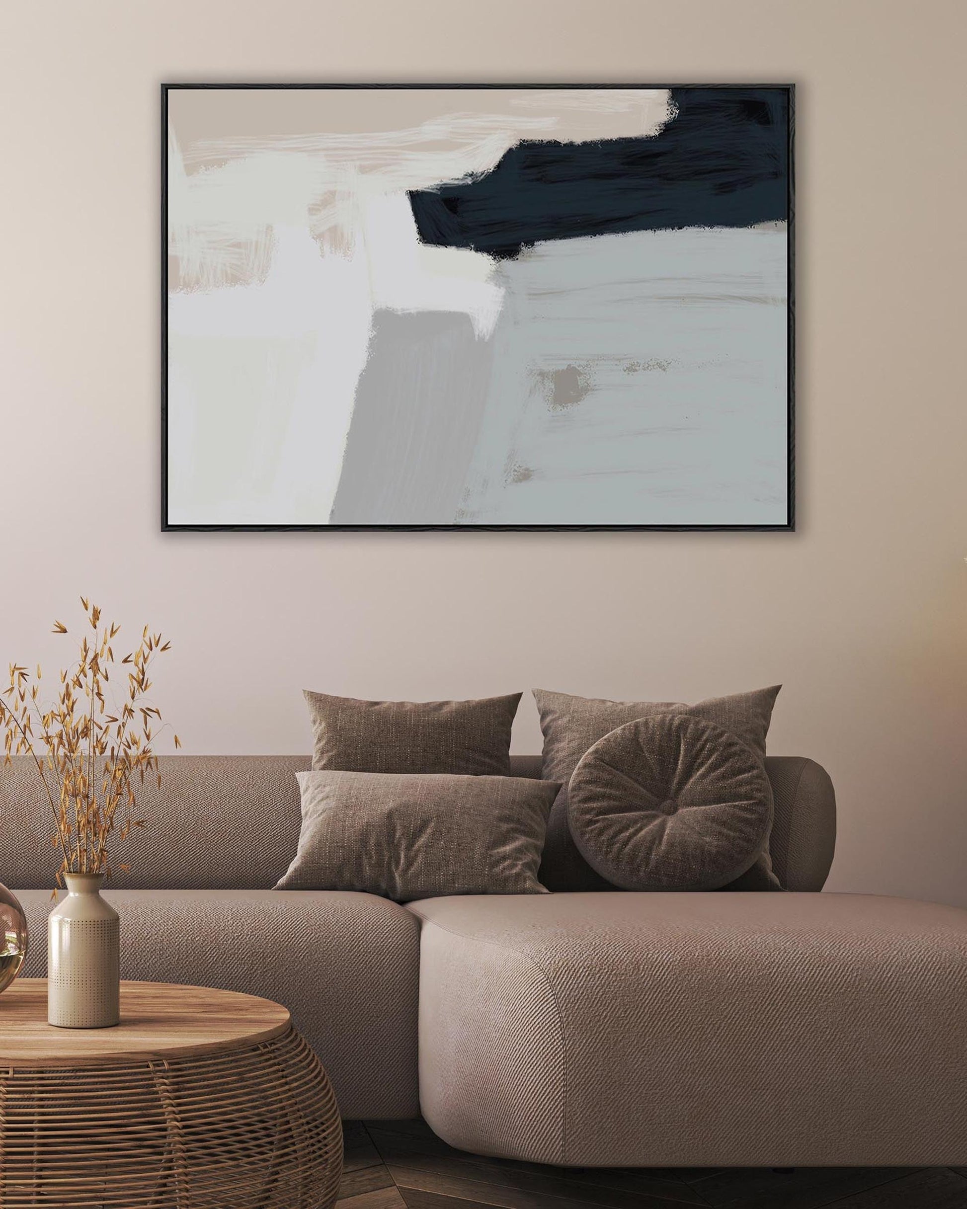 Modern living room with a gray sofa, abstract art on the wall, and decorative items.