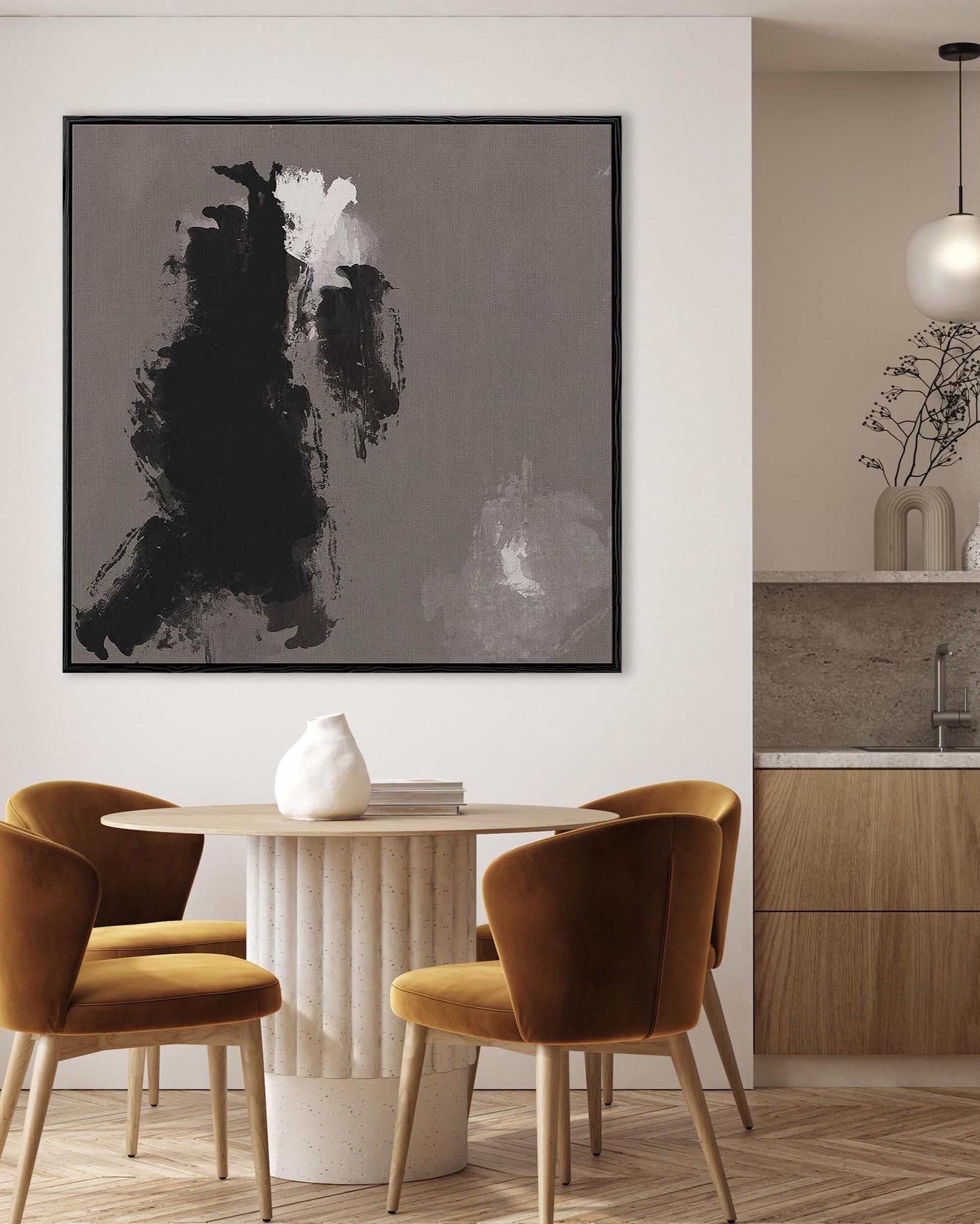 Modern interior with a dining table and chairs, abstract art on the wall, and a kitchen area.