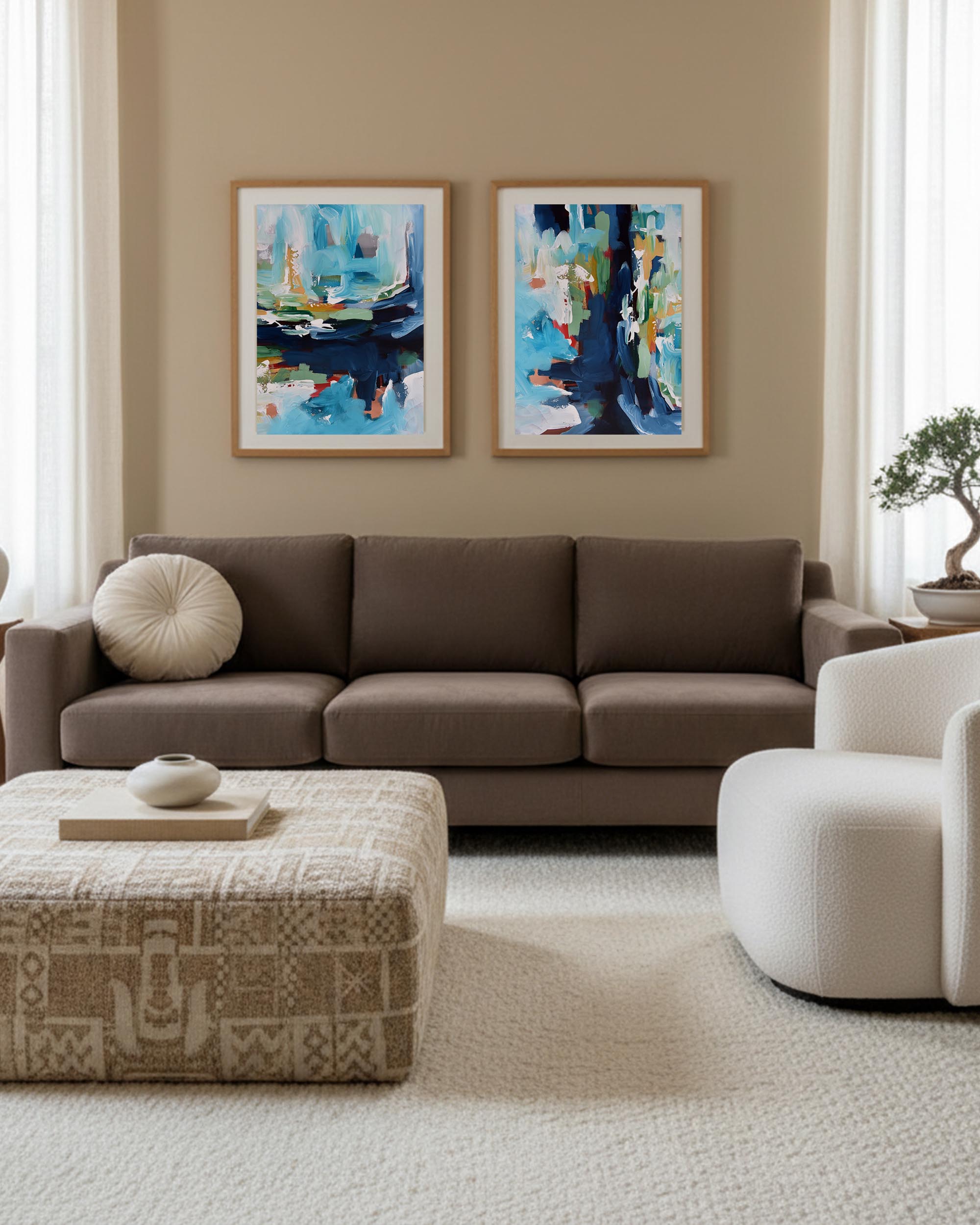 two piece abstract wall art pictures in living room wall, minimalist contemporary style aesthetic white chair and brown 3 seater sofa